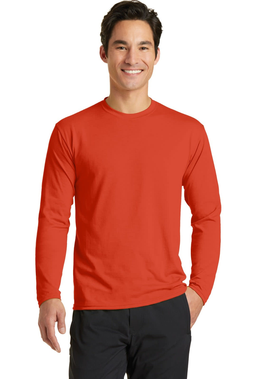 A man wearing a long sleeve performance blend tee in bright red. The shirt has a logo on it.