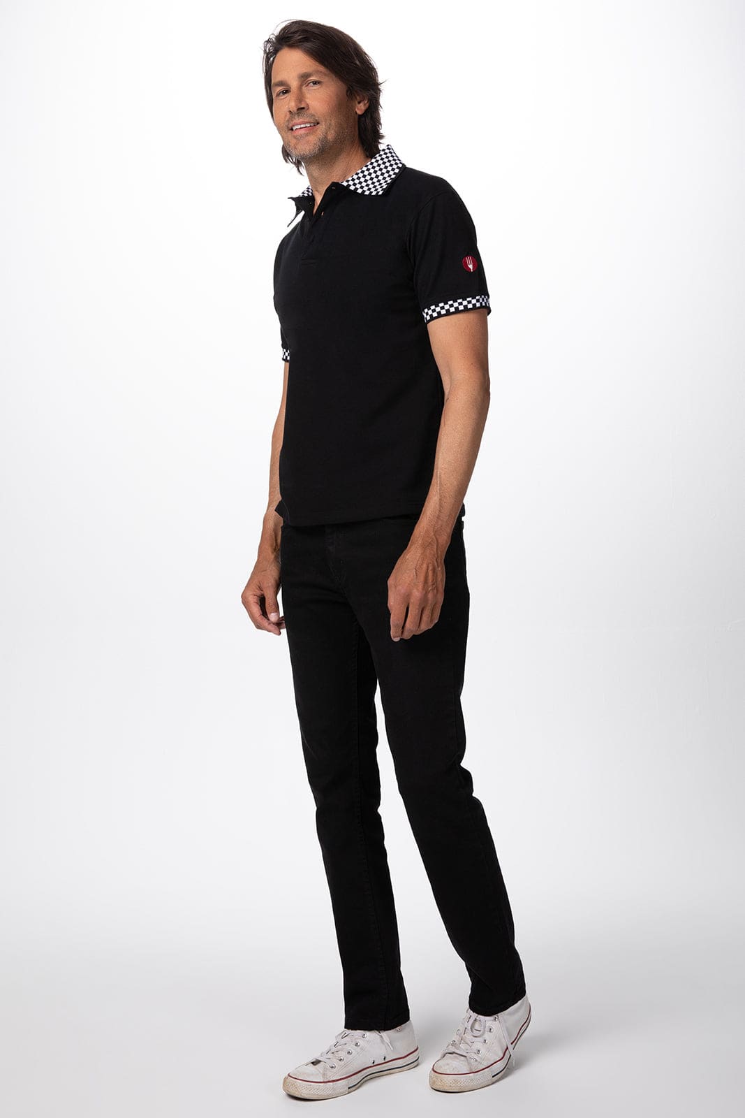 A black traditional men's polo shirt with a patterned collar and sleeves, featuring a logo on the sleeve.