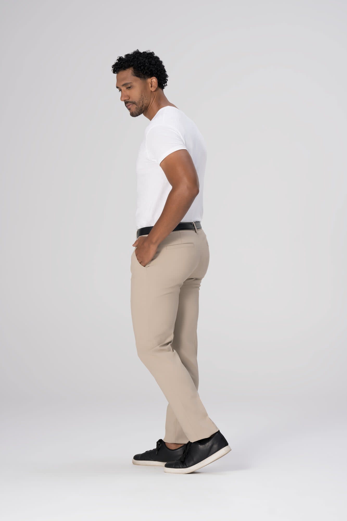 Chino men's poly stretch pants in beige, featuring a side view model wearing a white t-shirt and black belt with shoes.