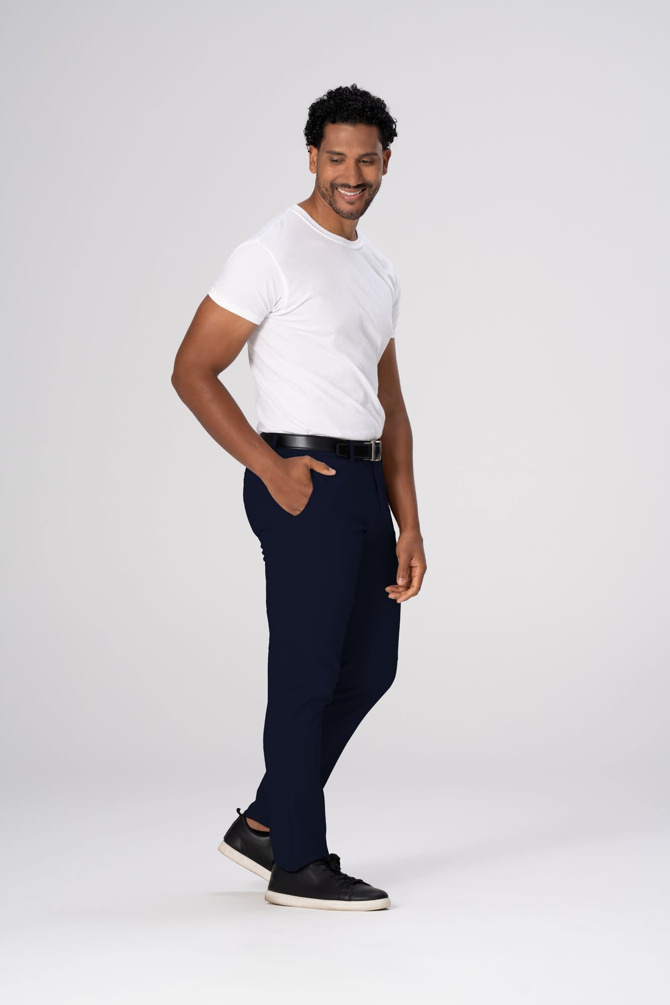 Chino men's poly stretch pants in navy, paired with a white t-shirt and black shoes, featuring a belt.