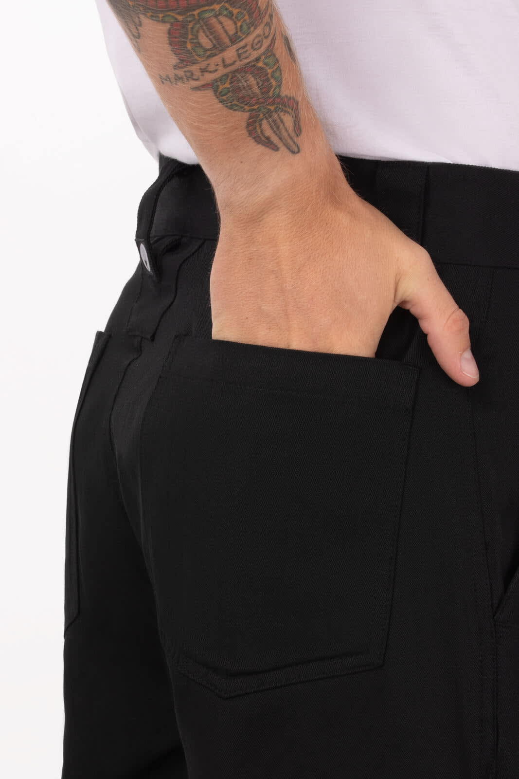 Black chef pants featuring a back pocket and a fitted design, showcasing a hand in the pocket.