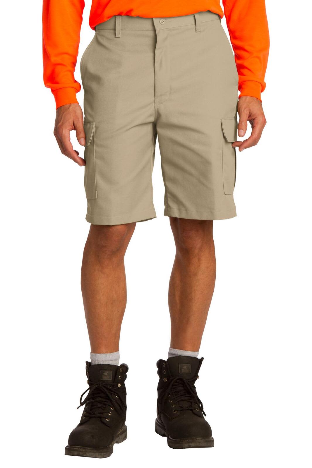 Cargo shorts in a light beige colour, featuring multiple pockets, worn with a bright orange long-sleeve shirt and boots.