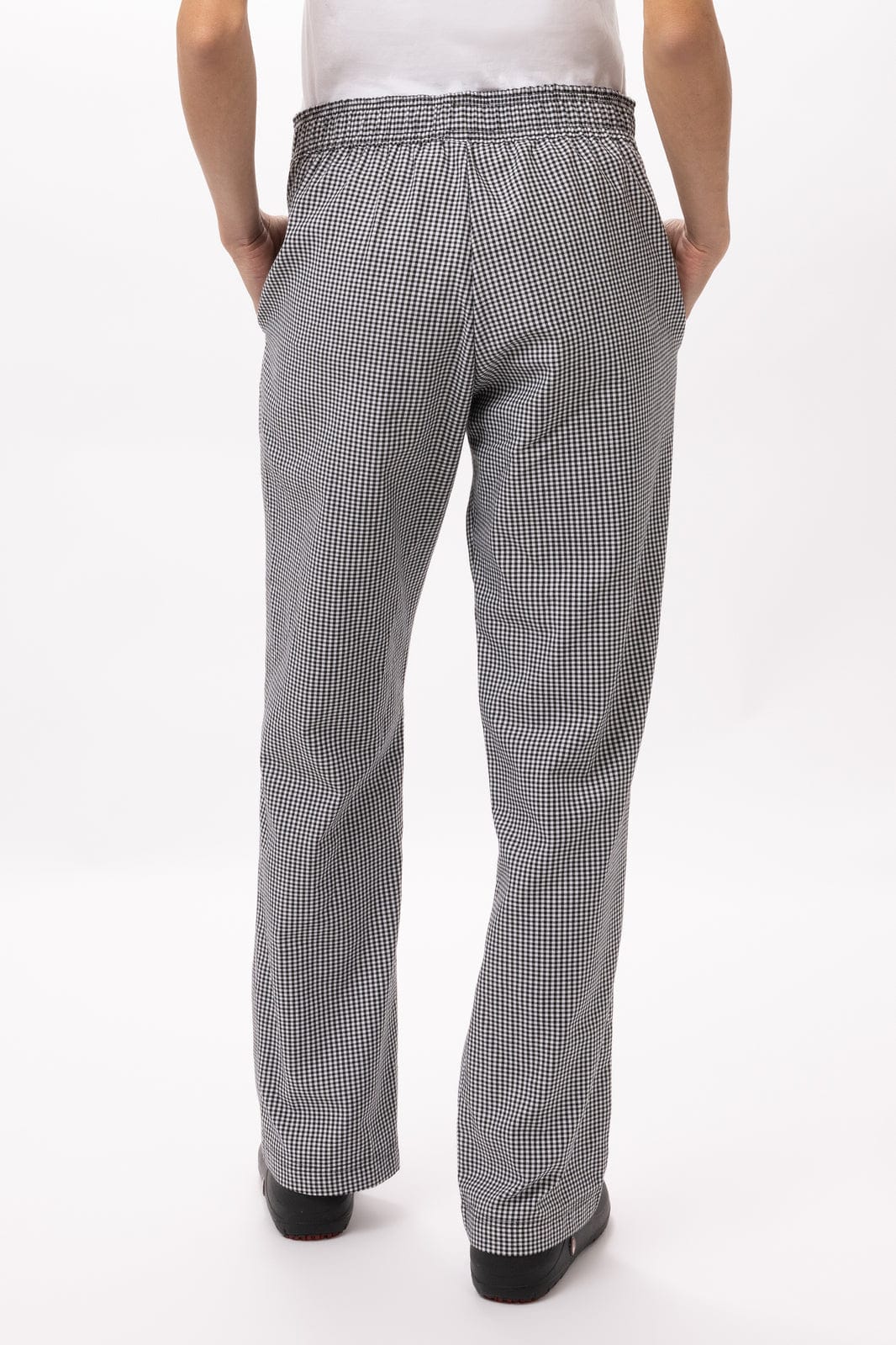 Baggy women's chef pants in a black and white check pattern, featuring an elastic waistband and straight-leg design.