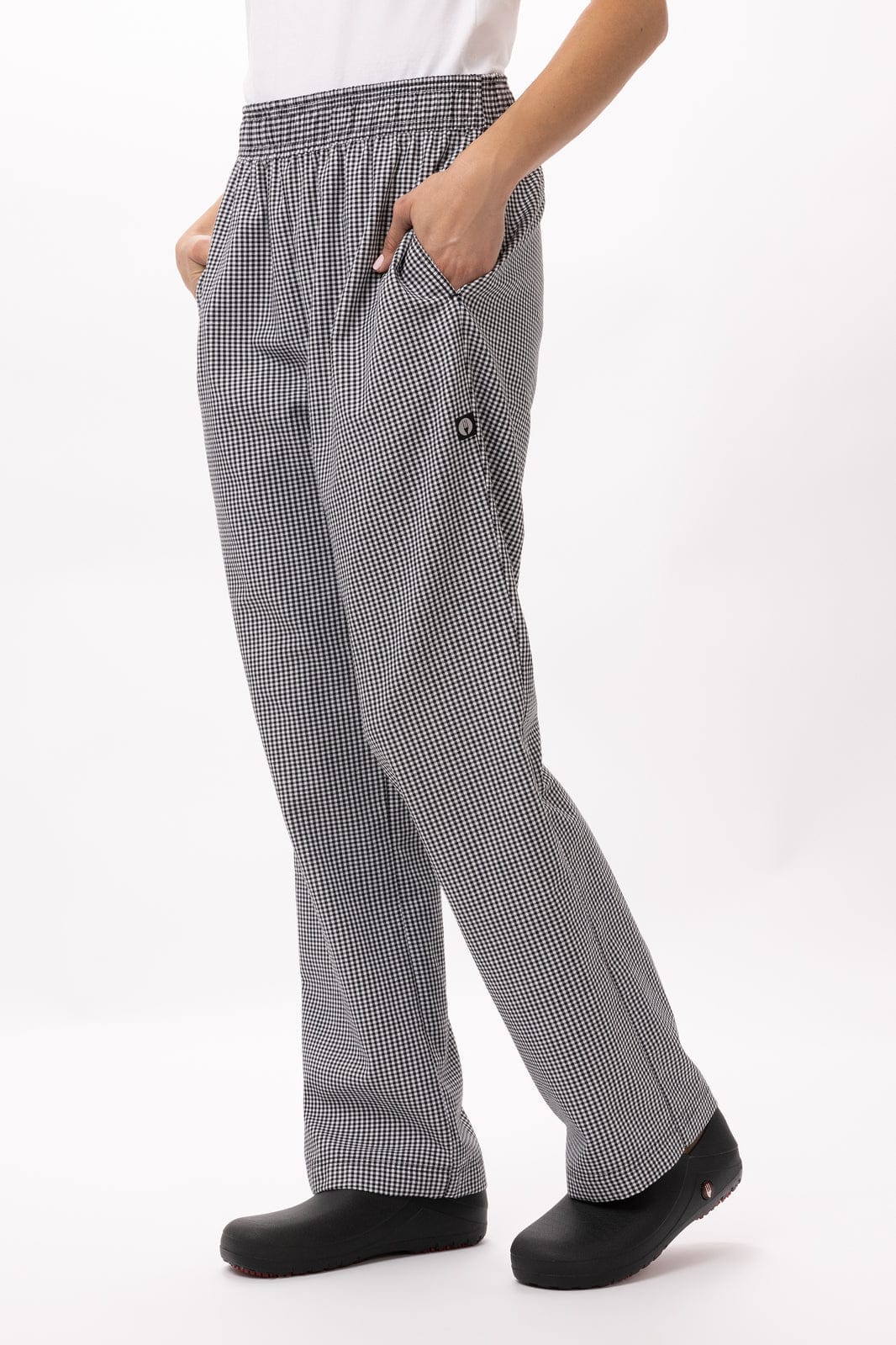Baggy women's chef pants in a black and white check pattern, featuring an elastic waist and pockets.