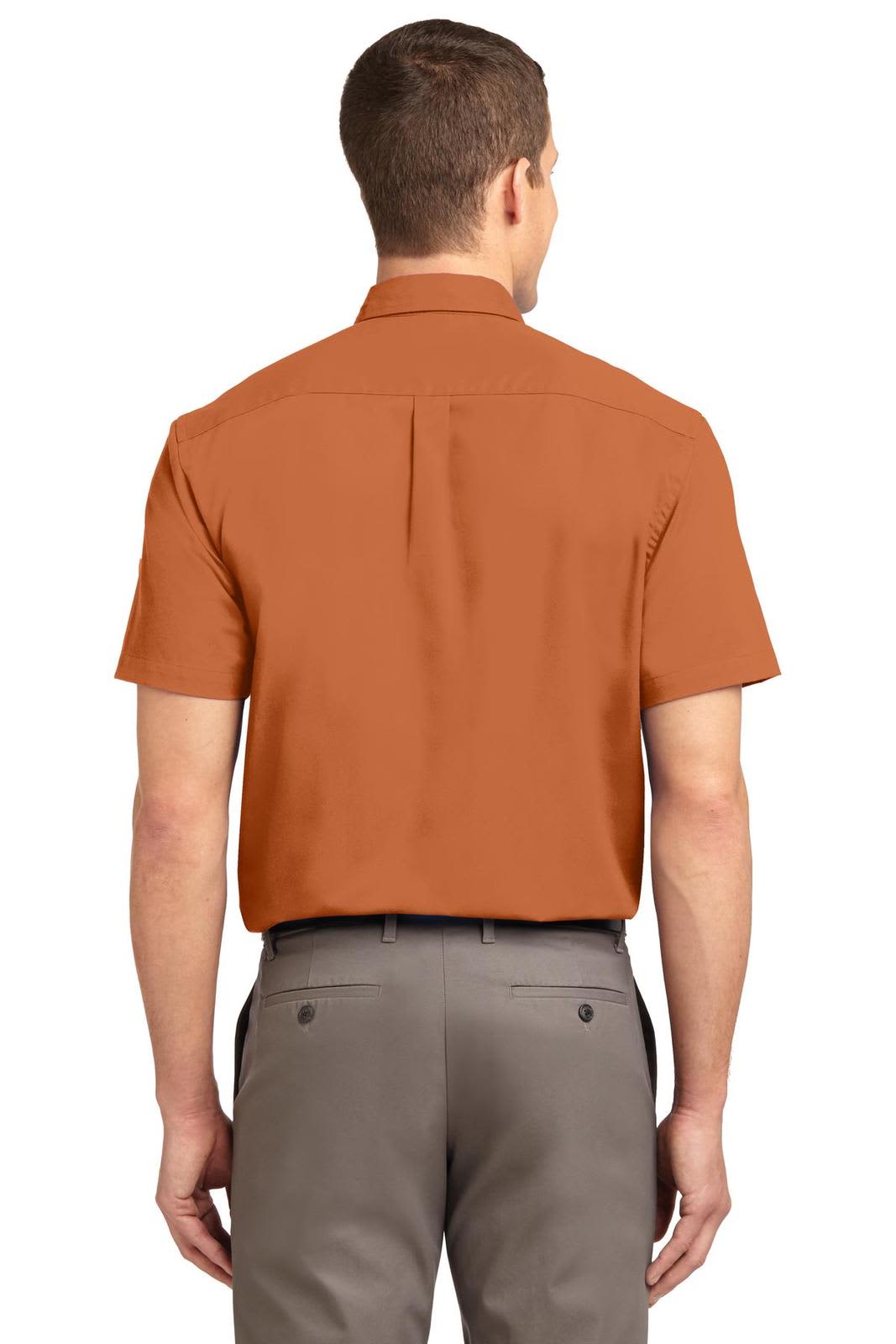 An orange short sleeve button-up shirt with a standard collar and a logo on the back.