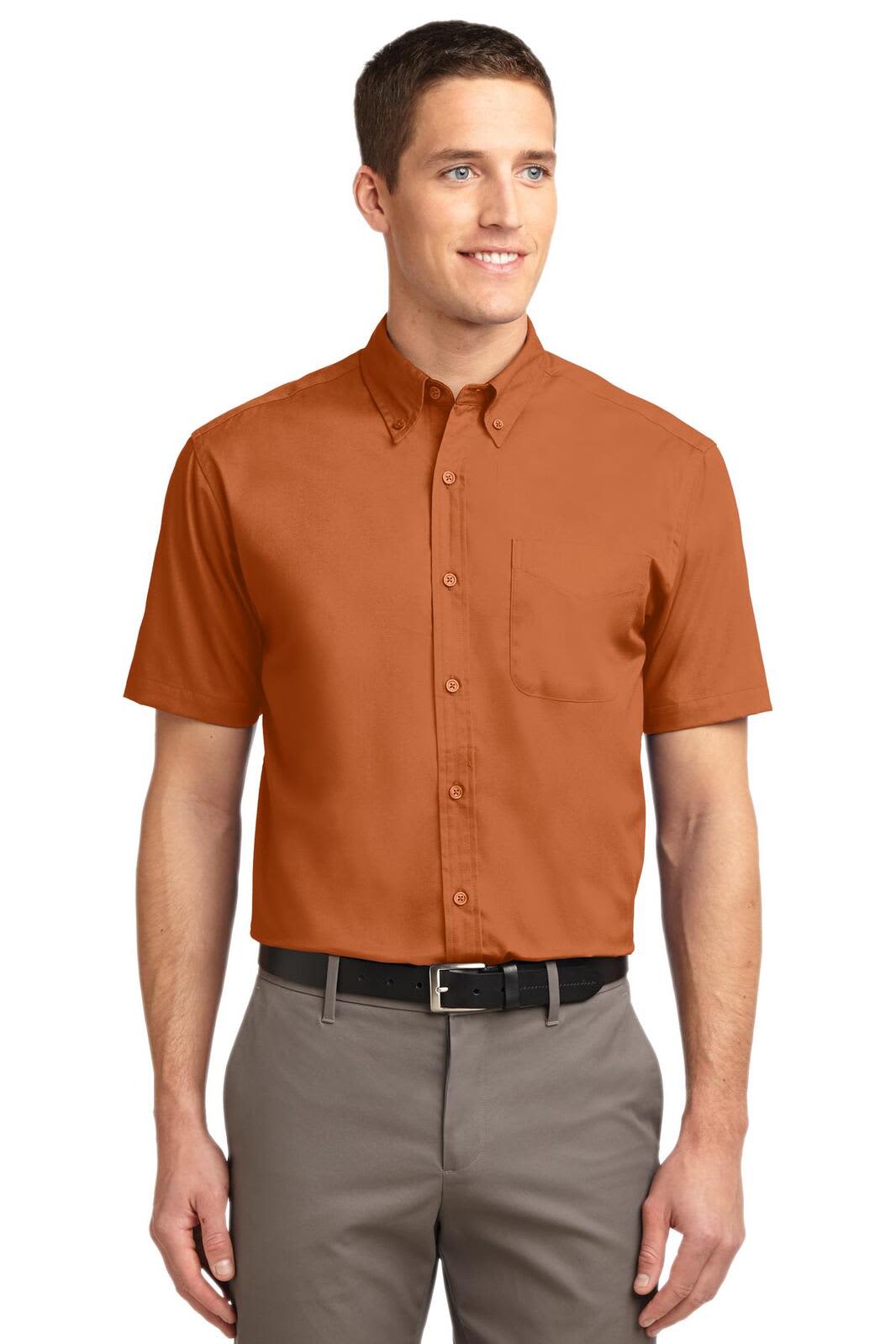 A short sleeve button-up shirt in a rich burnt orange hue, featuring a pocket and a branding logo.