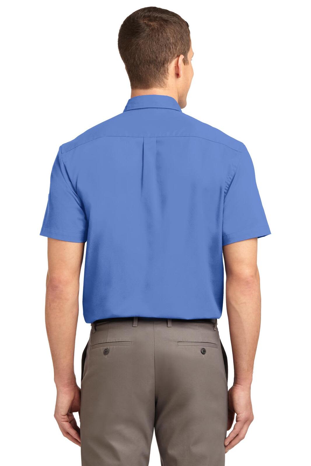 A blue short sleeve button-up shirt with a back yoke and a plain design. The model is wearing grey trousers.