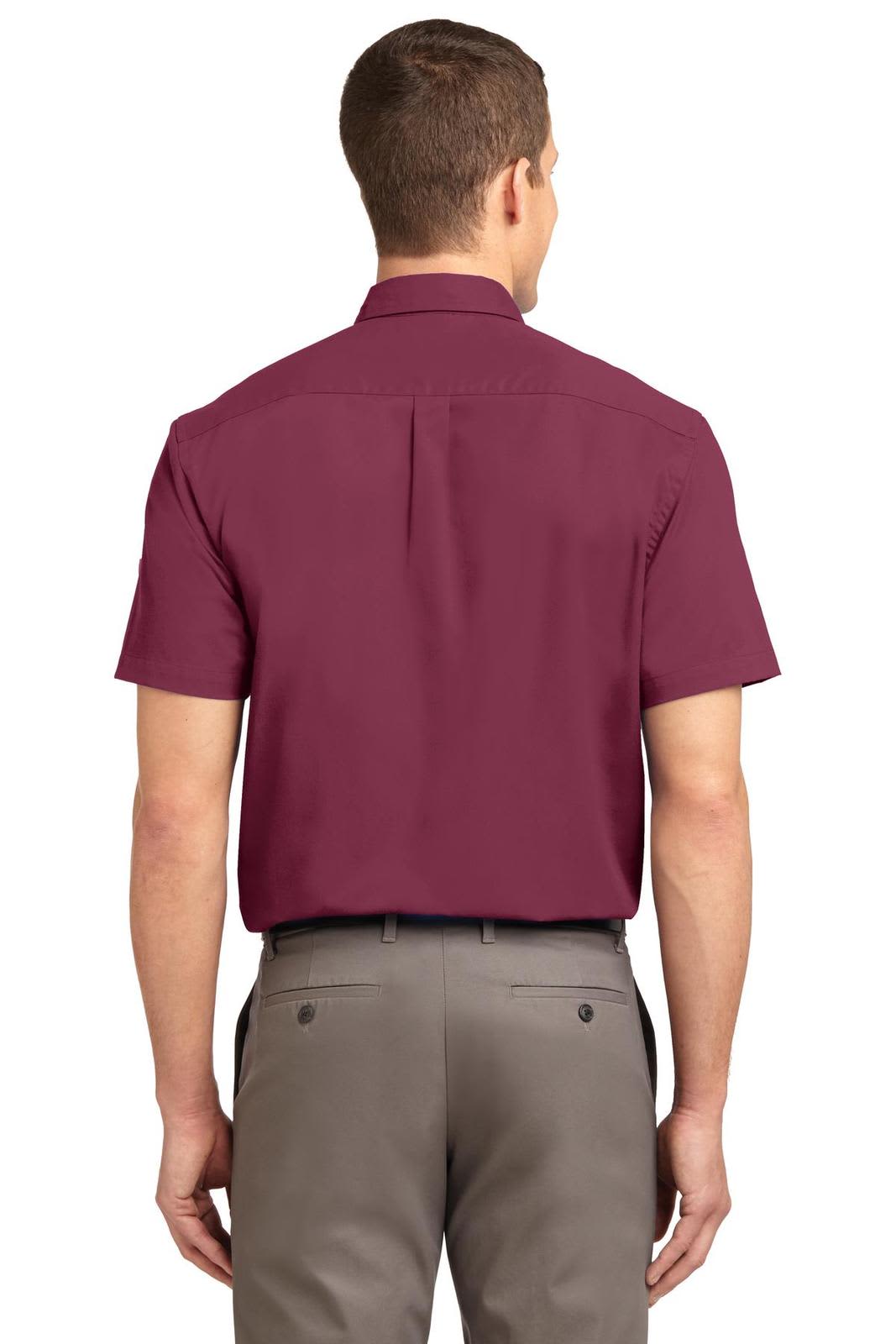 A short sleeve button-up shirt in burgundy, featuring a back yoke and has a logo.