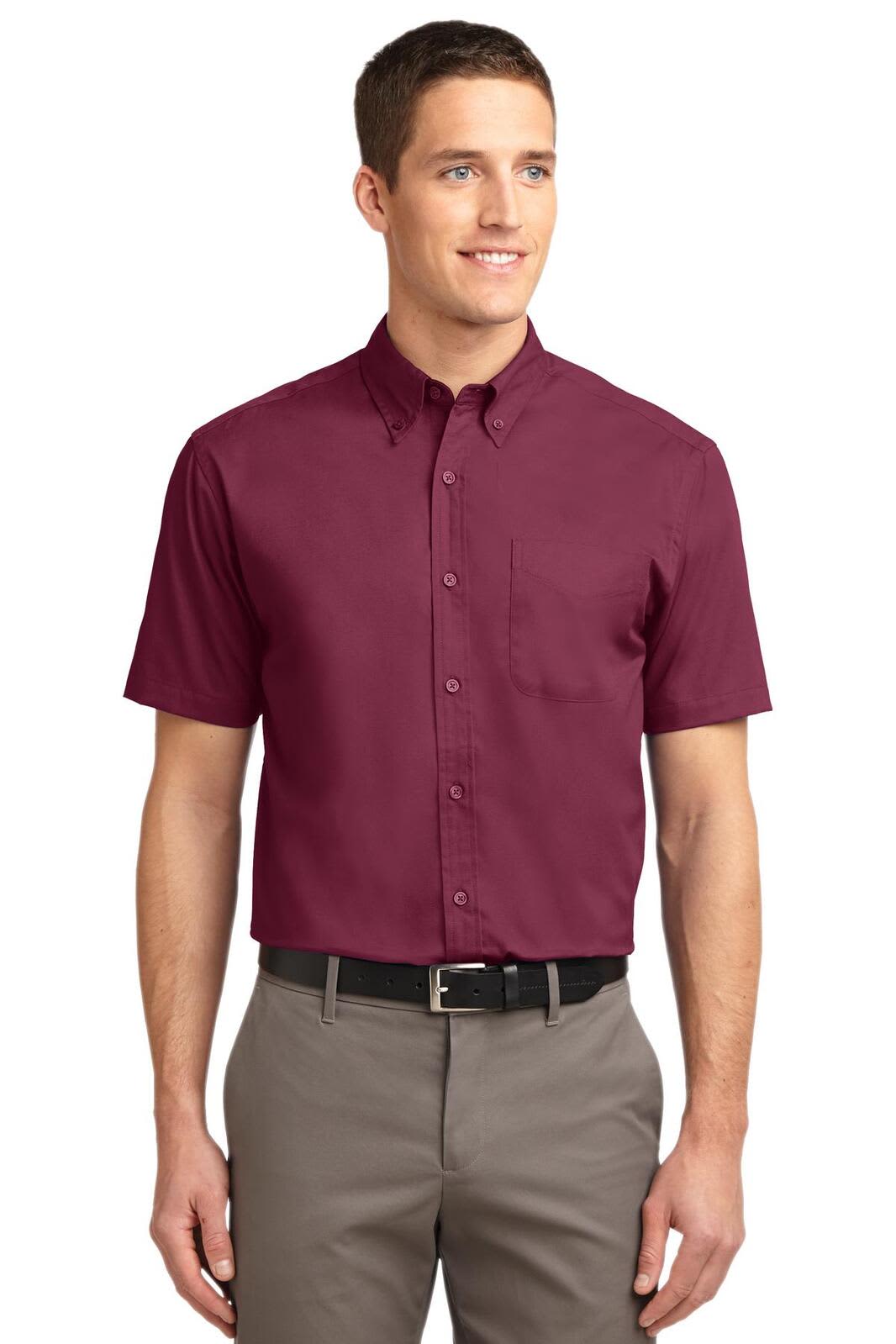 A maroon short sleeve button-up shirt on a model, featuring a collar and a logo on the chest.