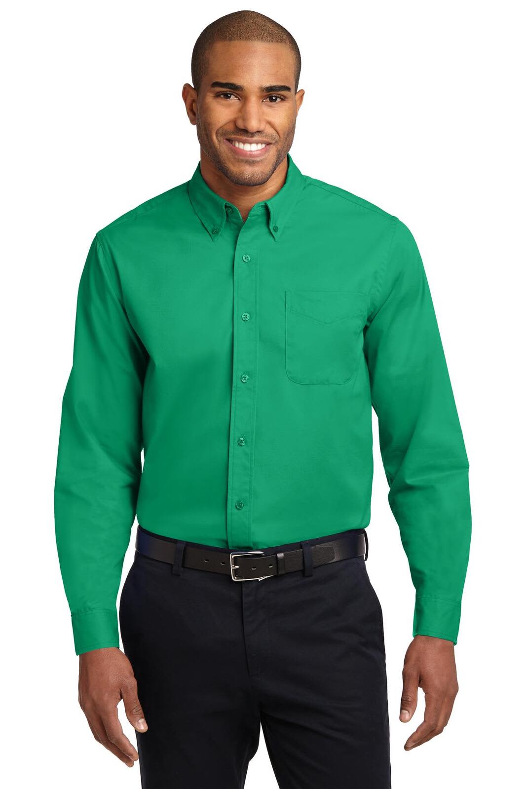 A long sleeve button-up shirt in green, featuring a pocket and a logo, worn by a man with a friendly smile.