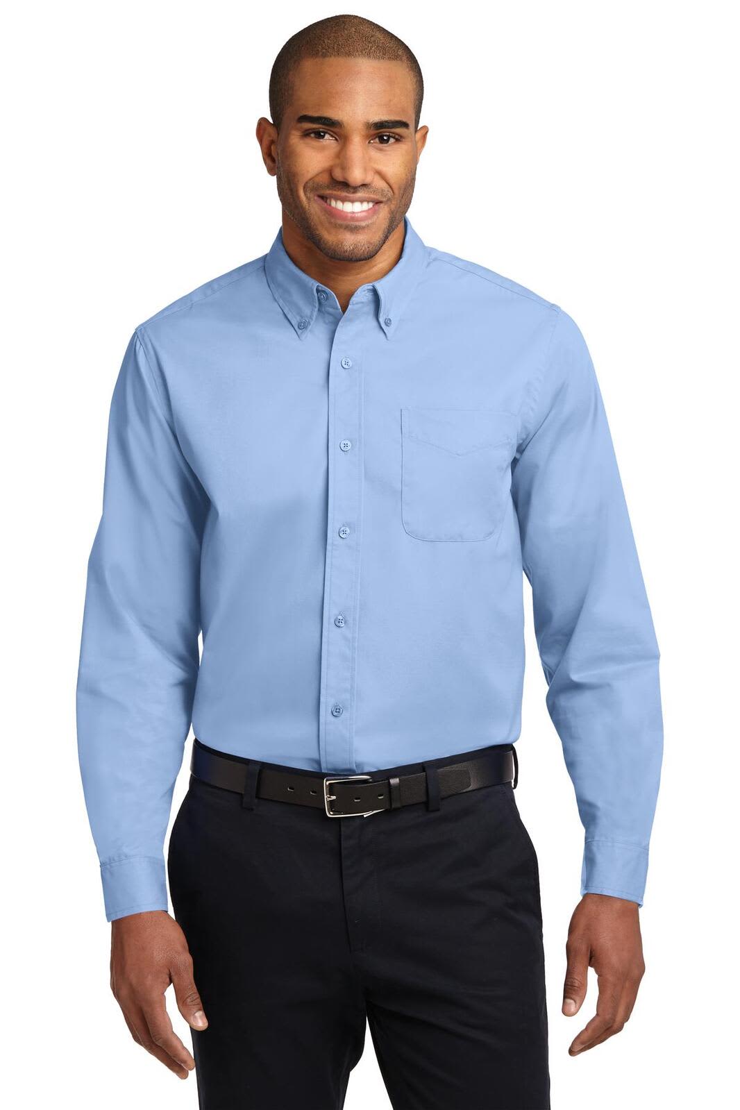 A man wearing a light blue long sleeve button-up shirt with a pocket and black trousers, featuring a logo.