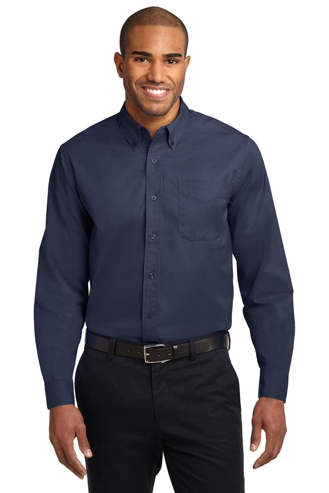 A navy long sleeve button-up shirt with a chest pocket, worn by a smiling male model. Features a logo on the shirt.