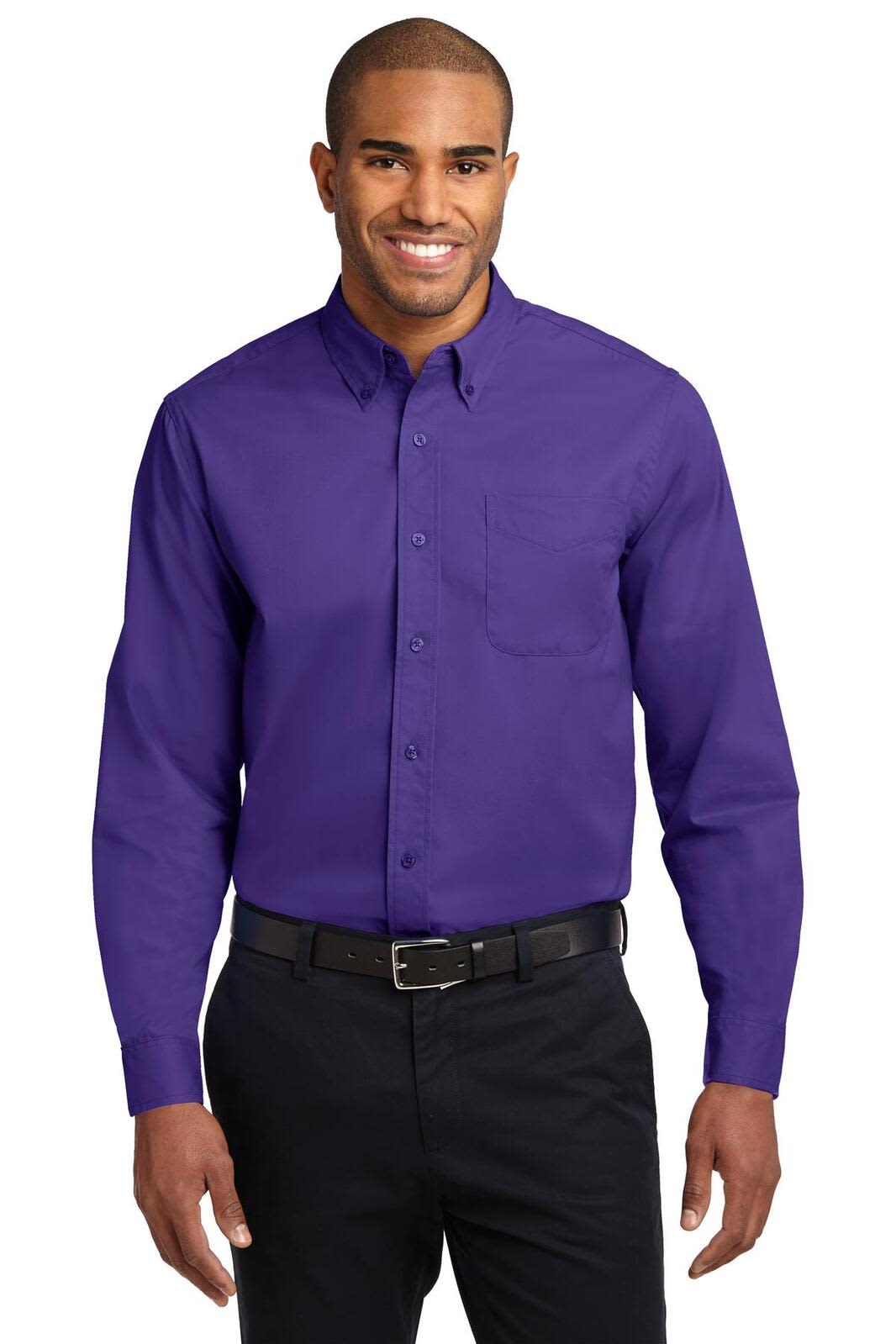A man is wearing a long sleeve button-up shirt in purple, featuring a chest pocket and a logo.