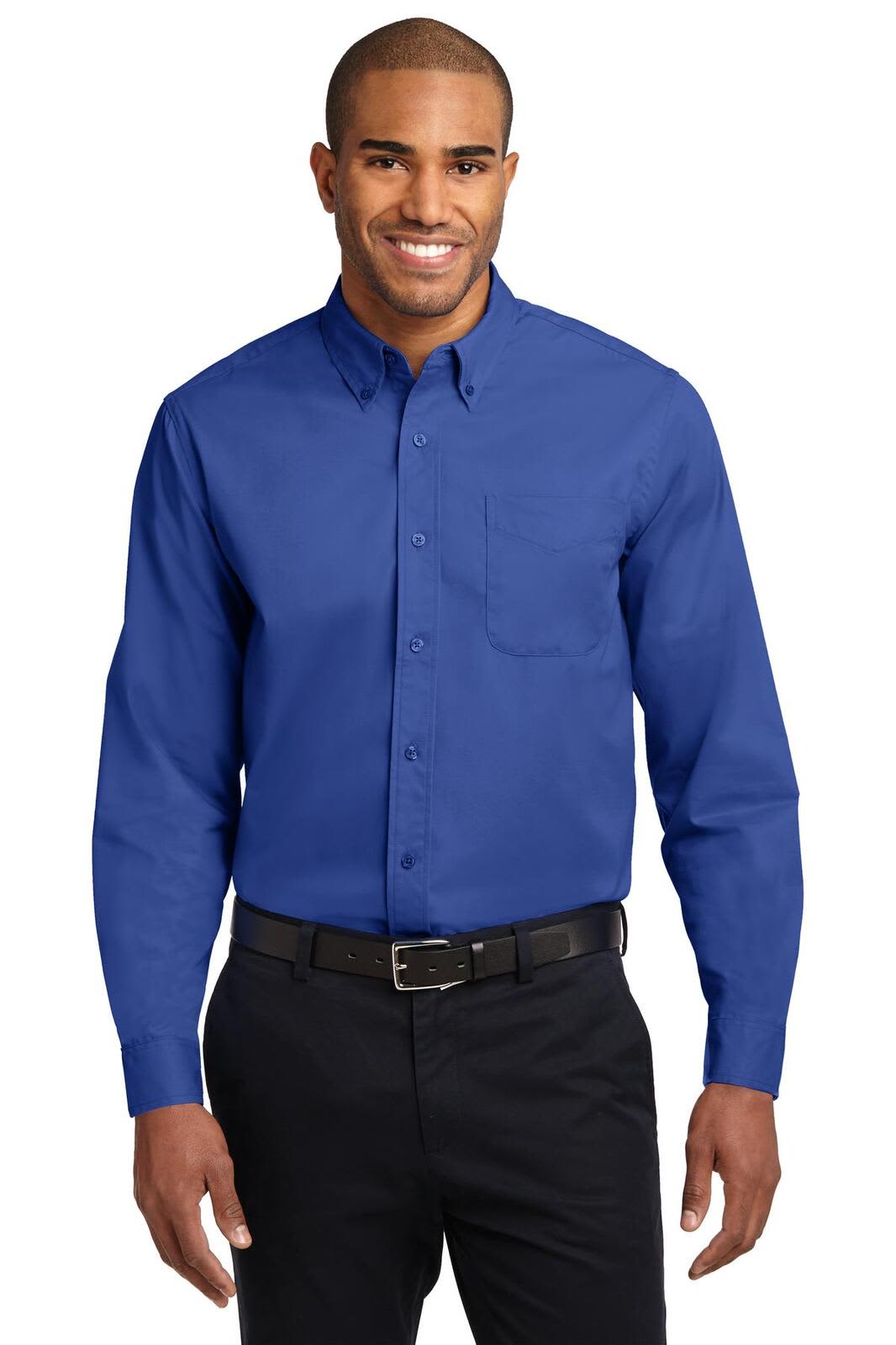A man wearing a blue long sleeve button-up shirt with a pocket, paired with black trousers and a belt.