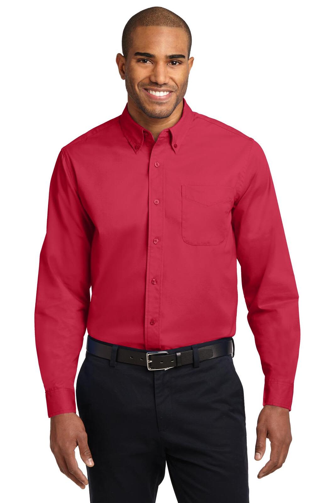A man wearing a red long sleeve button-up shirt with a pocket, paired with dark pants and a belt.