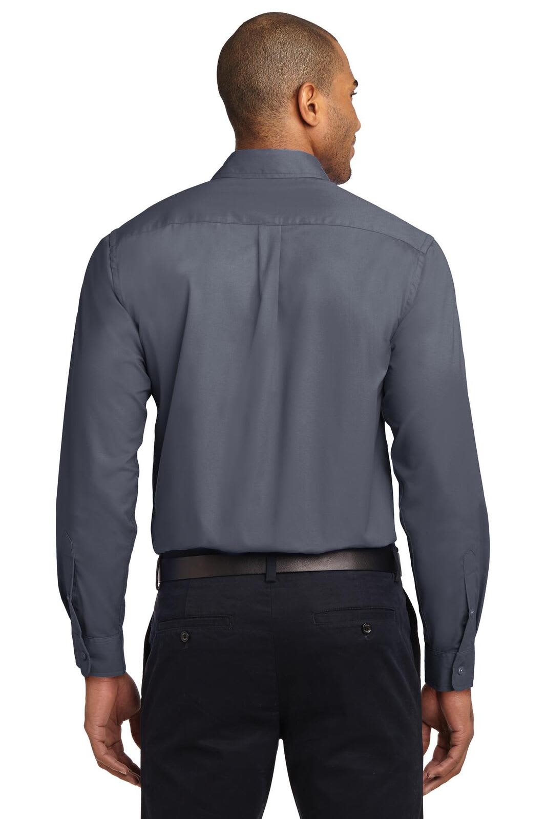 A man wearing a grey long sleeve button-up shirt, showing the back view, with dark trousers. The shirt has a logo.