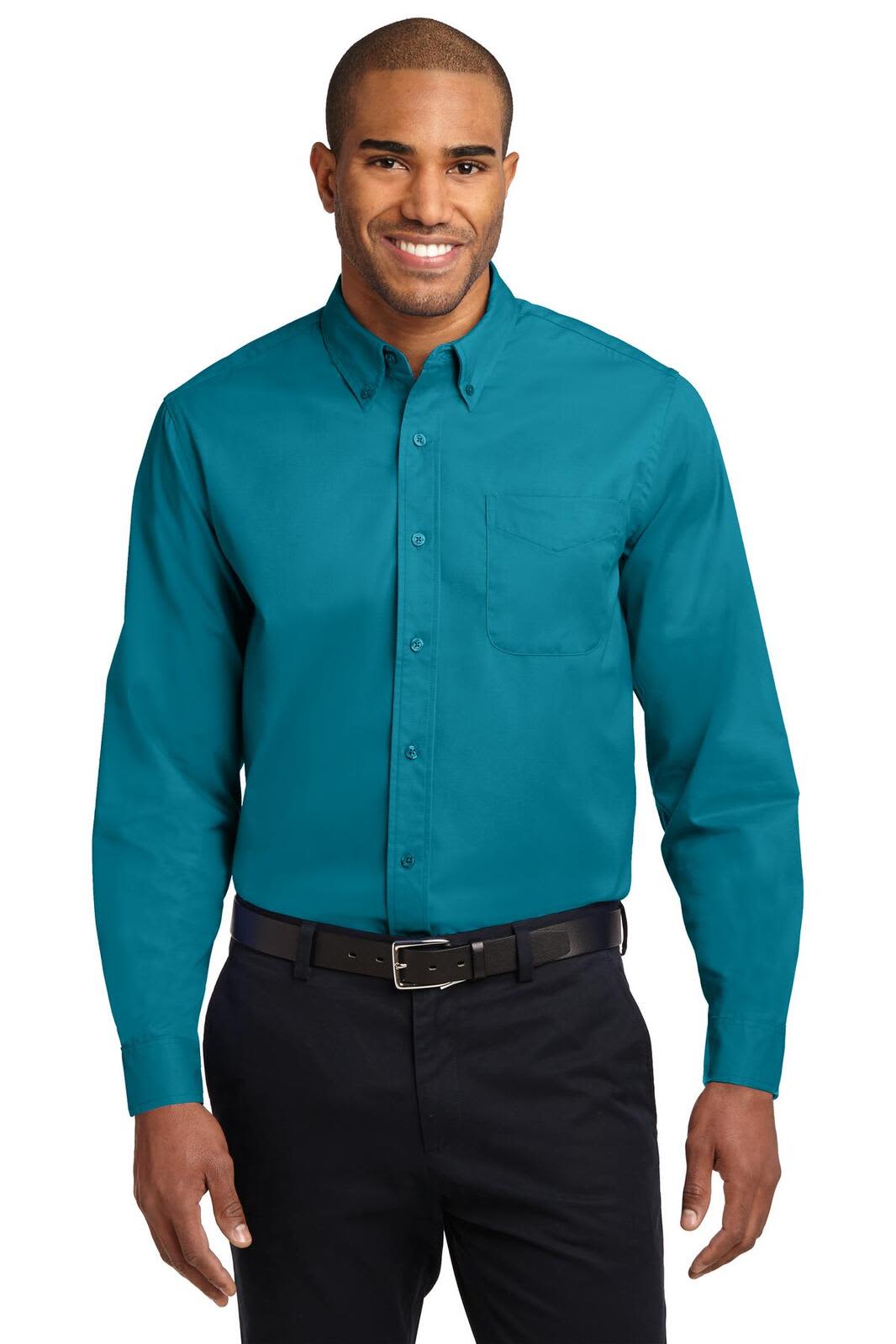 A long sleeve button-up shirt in teal, featuring a chest pocket and a logo on the chest.