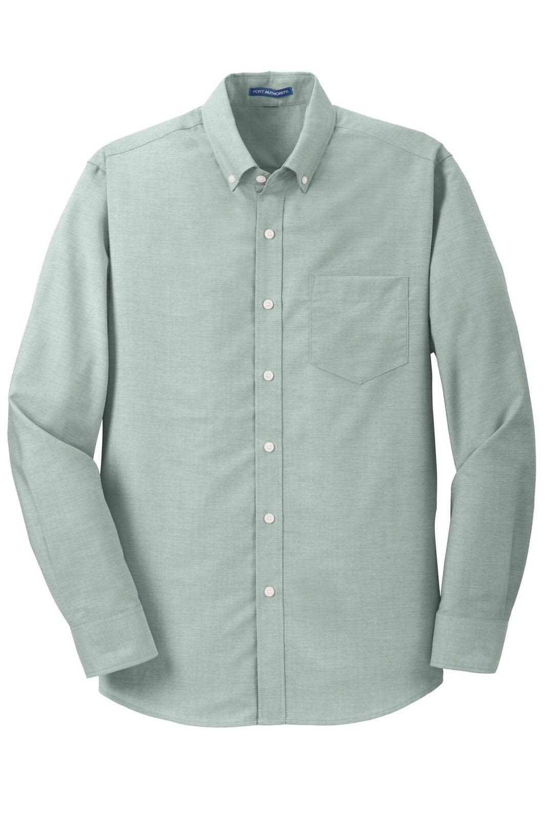 A button-up shirt in light green with a chest pocket and a subtle textured pattern. Features a brand logo.