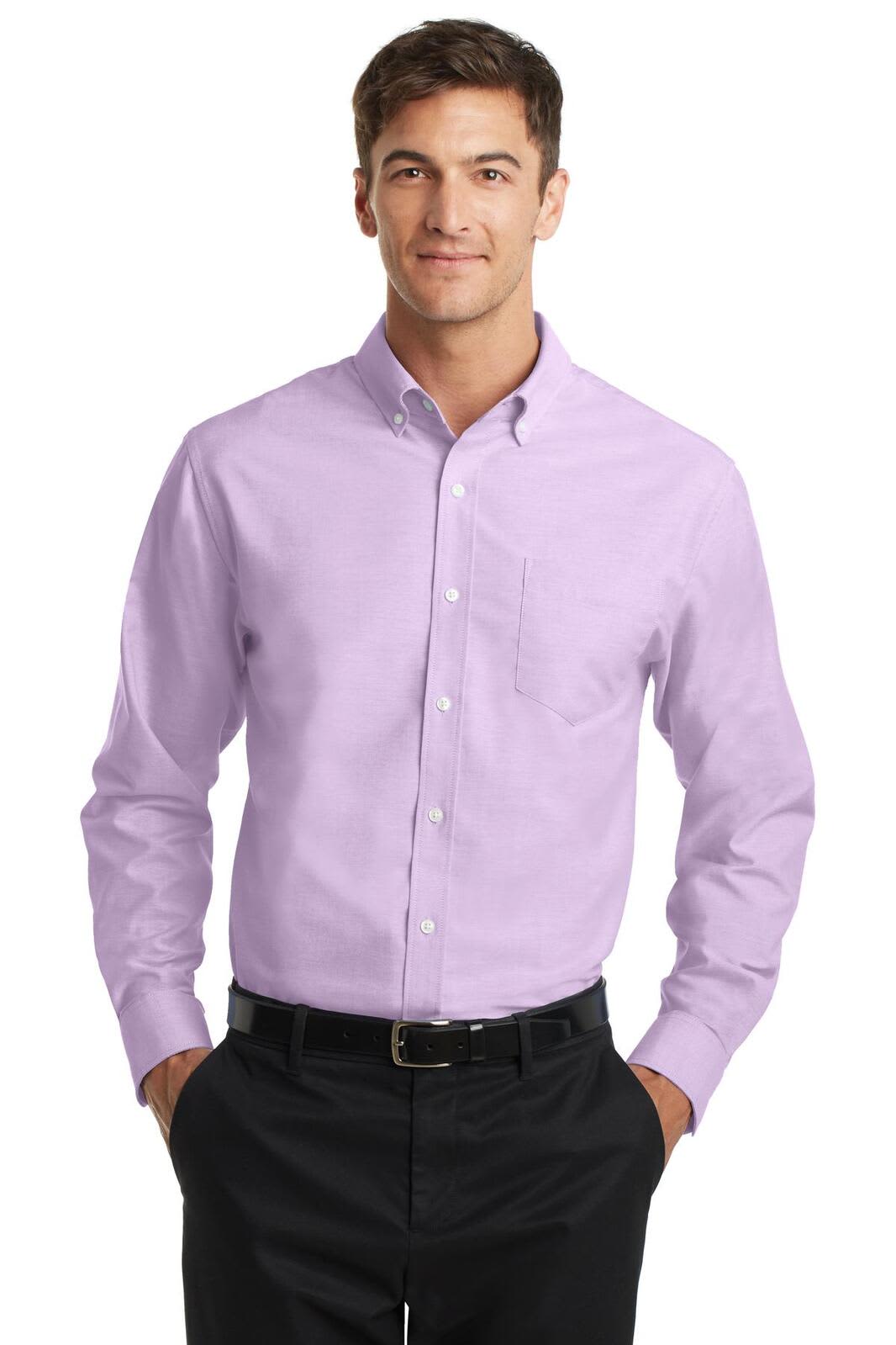 A light purple button-up shirt with long sleeves and a pocket, featuring a logo. Worn by a man standing with hands in pockets.