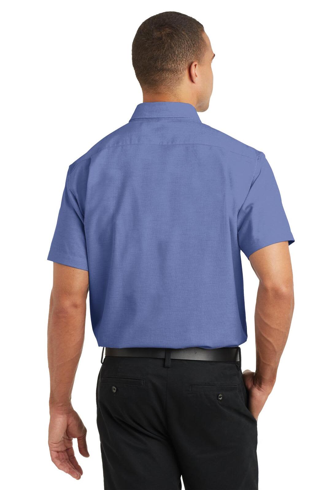 A man wearing a short-sleeve blue button-up shirt, viewed from the back, with a visible logo on the shirt.
