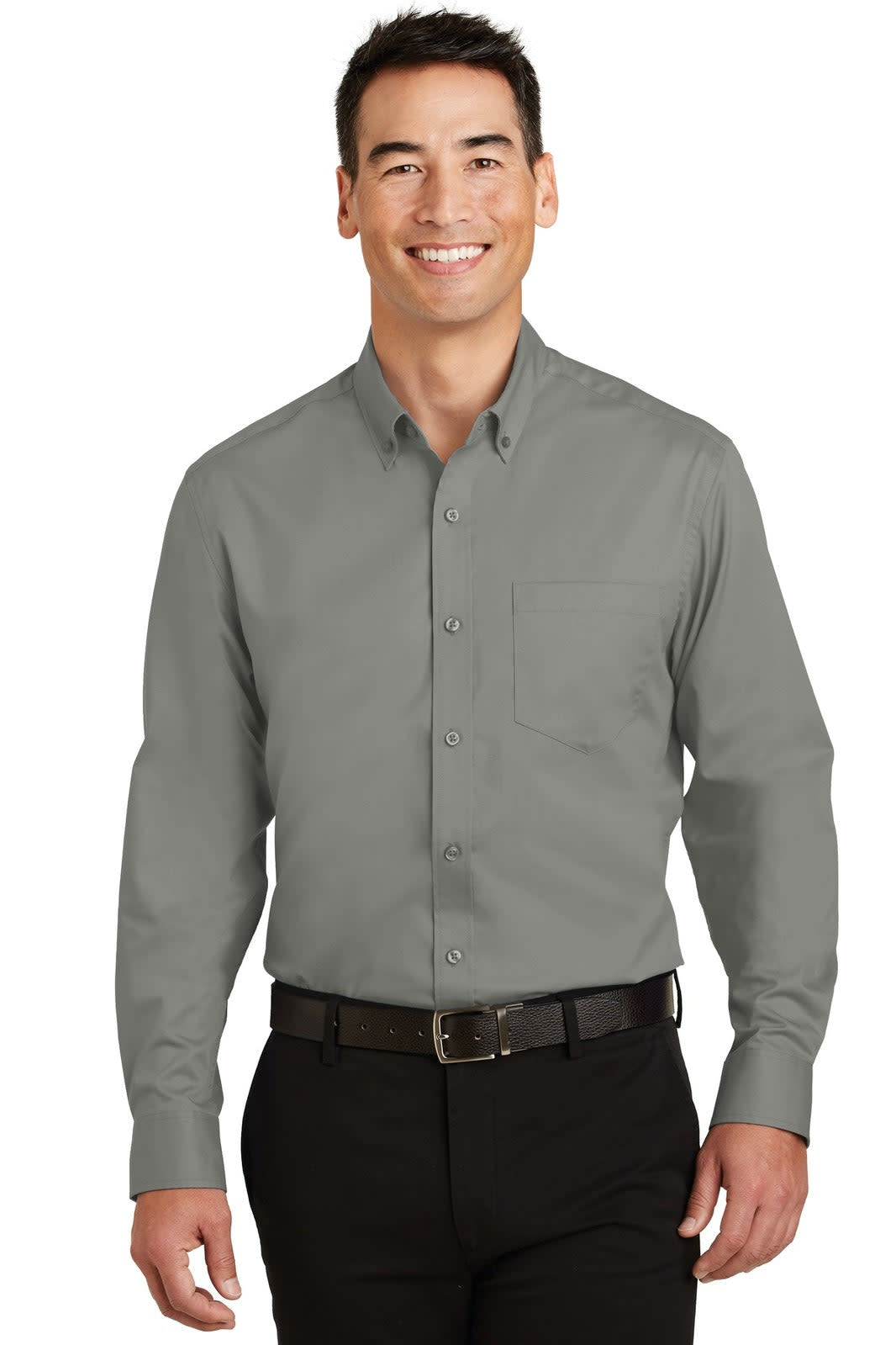 A man wearing a grey button-up shirt with a collar and a chest pocket, paired with dark trousers.