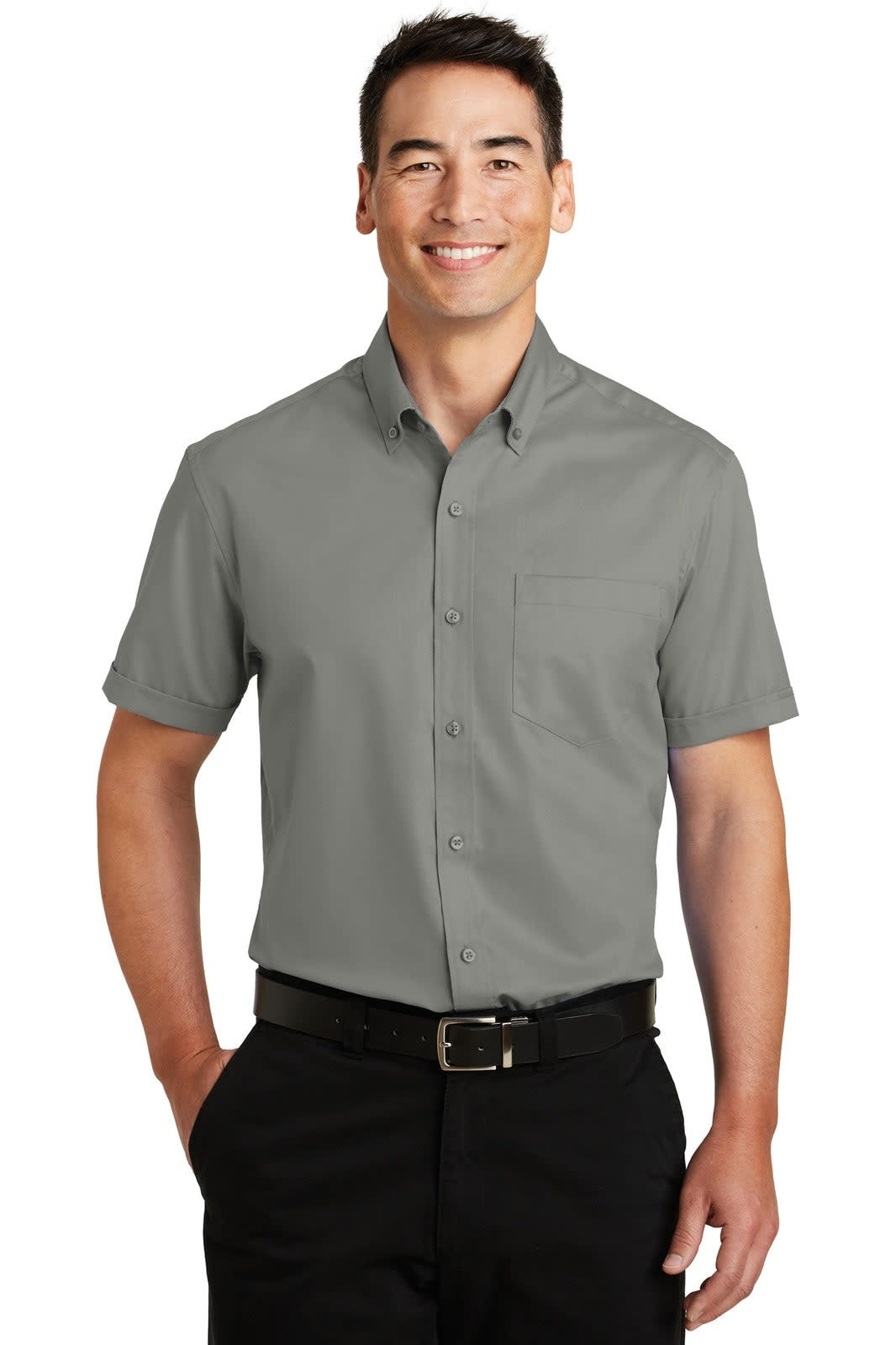 A short sleeve button-up shirt in grey, featuring a single pocket and a logo. Model is smiling while wearing it.