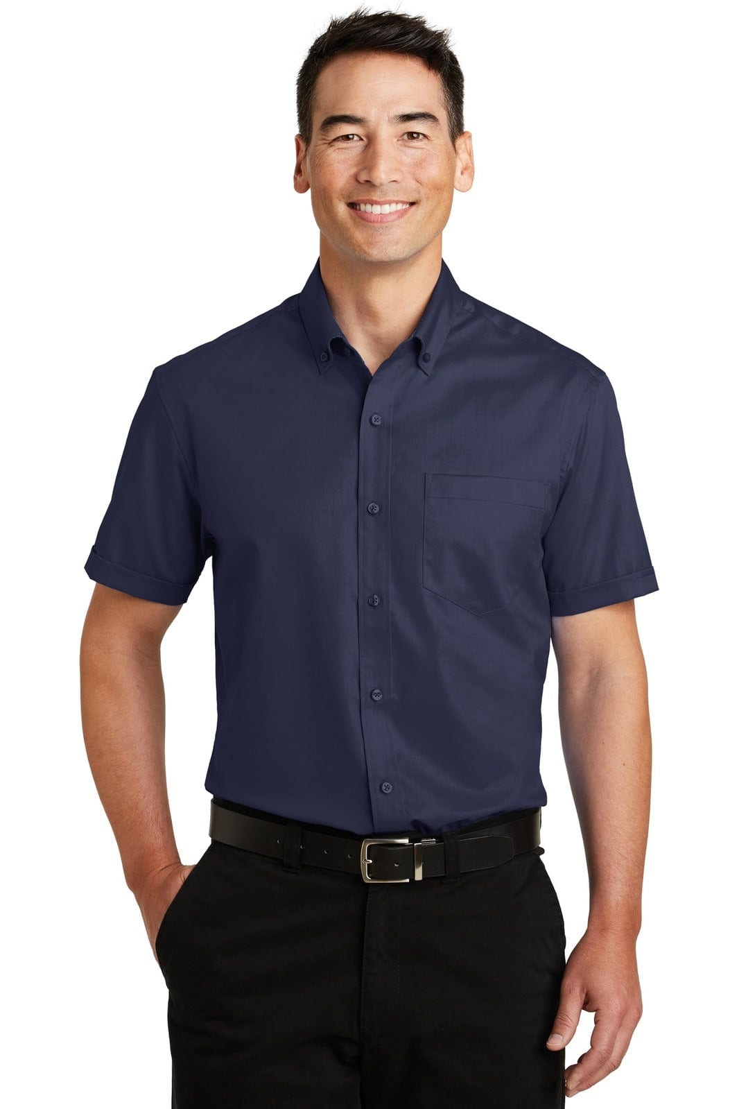 A man wearing a navy blue short sleeve button-up shirt with a pocket. The shirt has a logo on it.