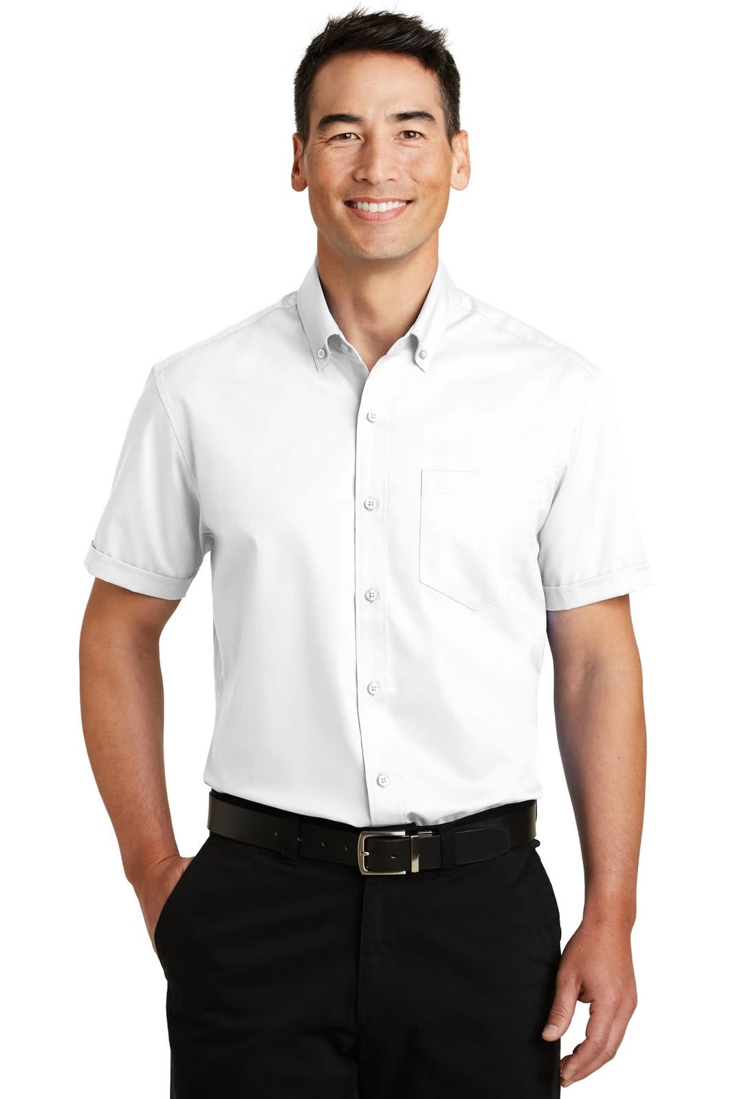 A man wearing a white short sleeve button-up shirt, featuring a pocket and a logo, paired with black trousers.