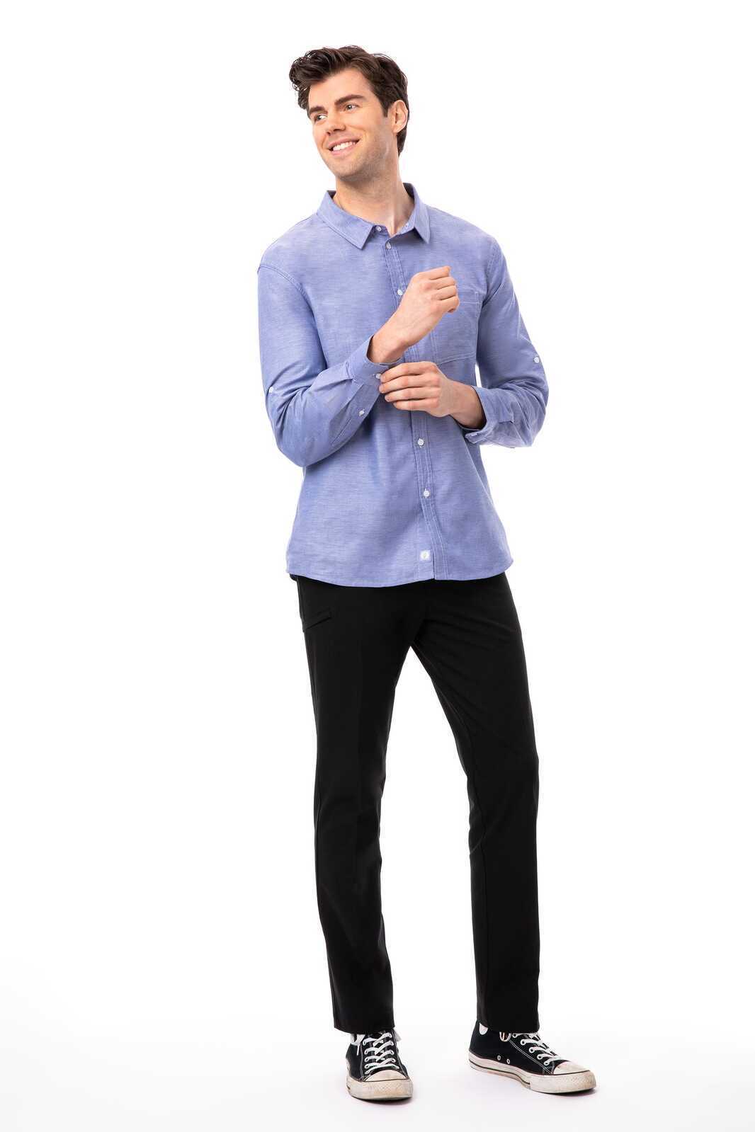 A blue button-up men's classic shirt with a collar, worn with black trousers and sneakers.