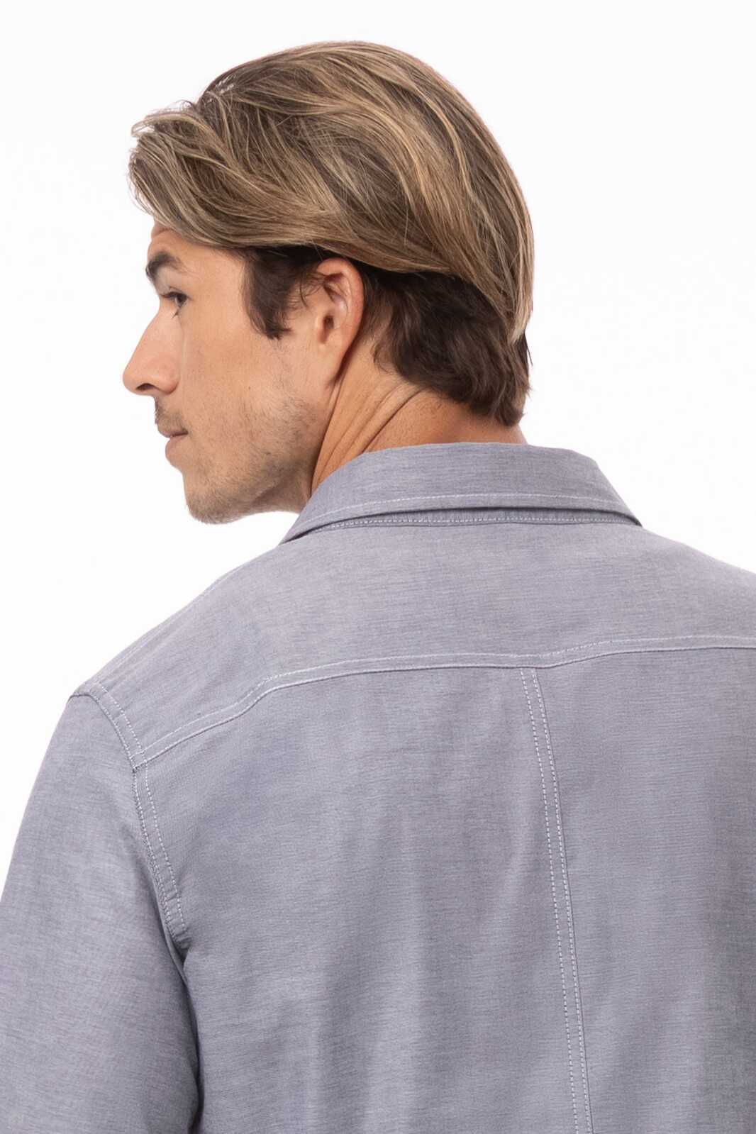 A men's classic button-up shirt in blue, featuring a back view with a collar and logo detail.