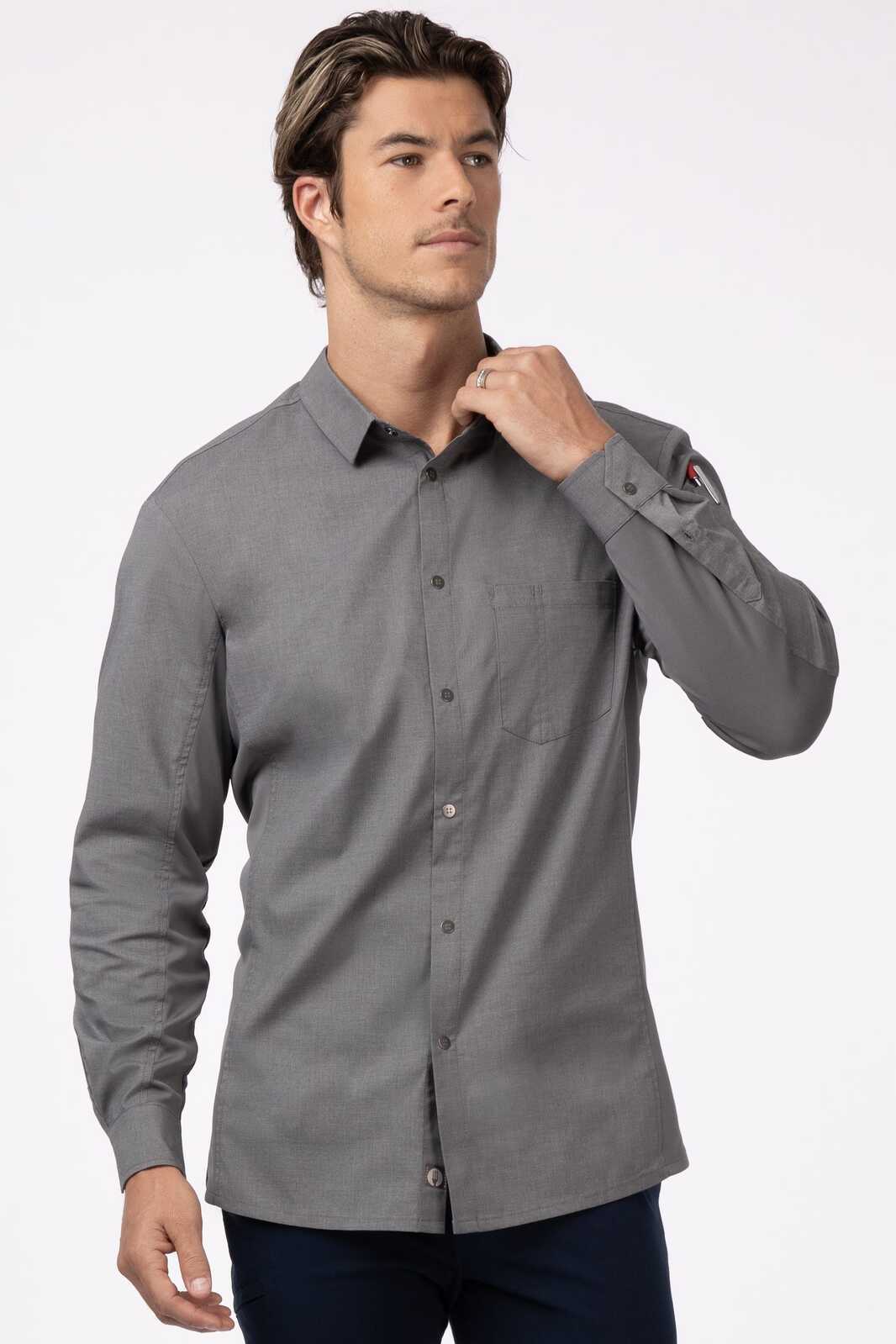 A grey men's shirt with long sleeves and a button-up front, featuring a pocket and a logo on the sleeve.