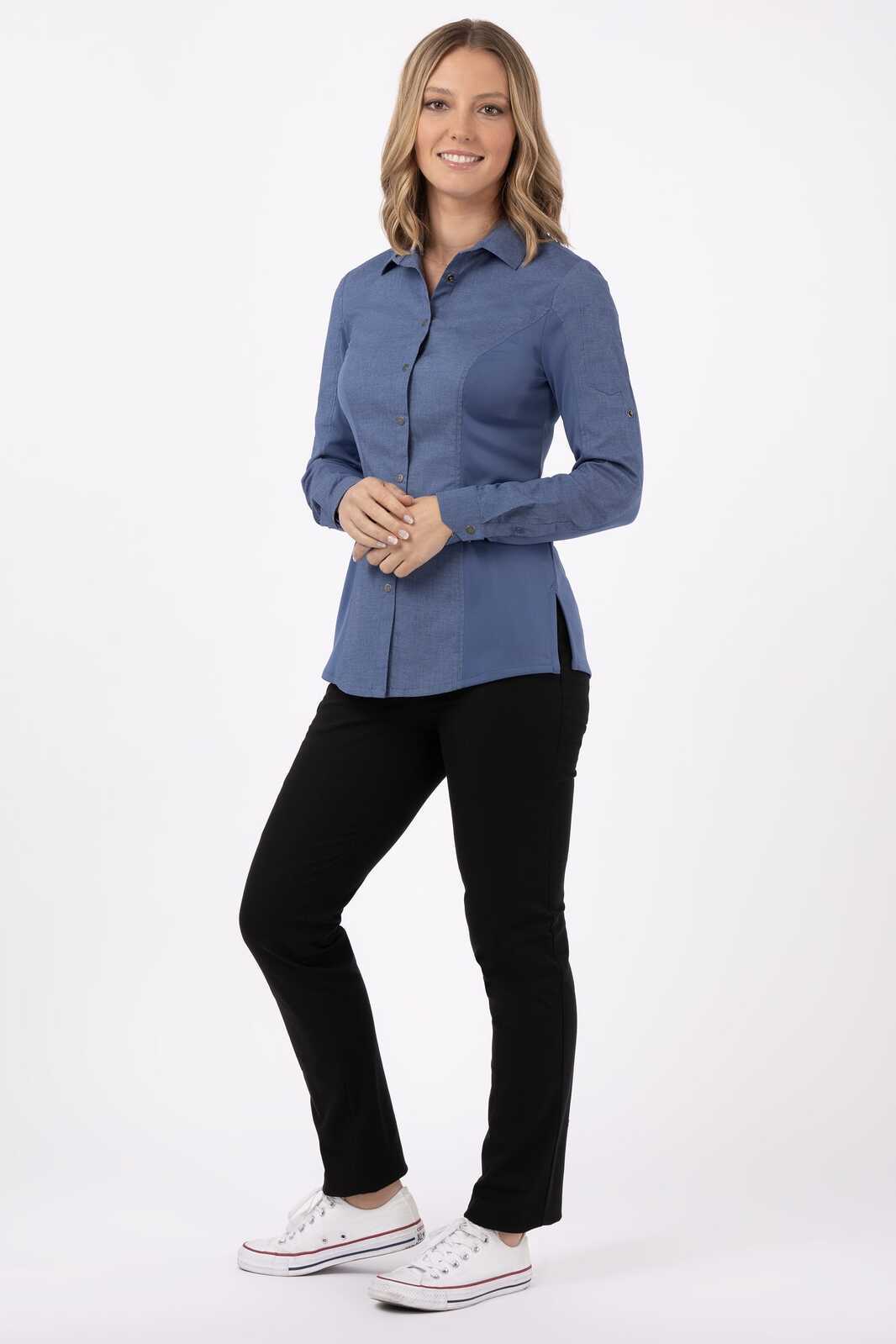 A blue women's shirt with long sleeves, paired with black pants and white shoes. The shirt features a collar and buttons.