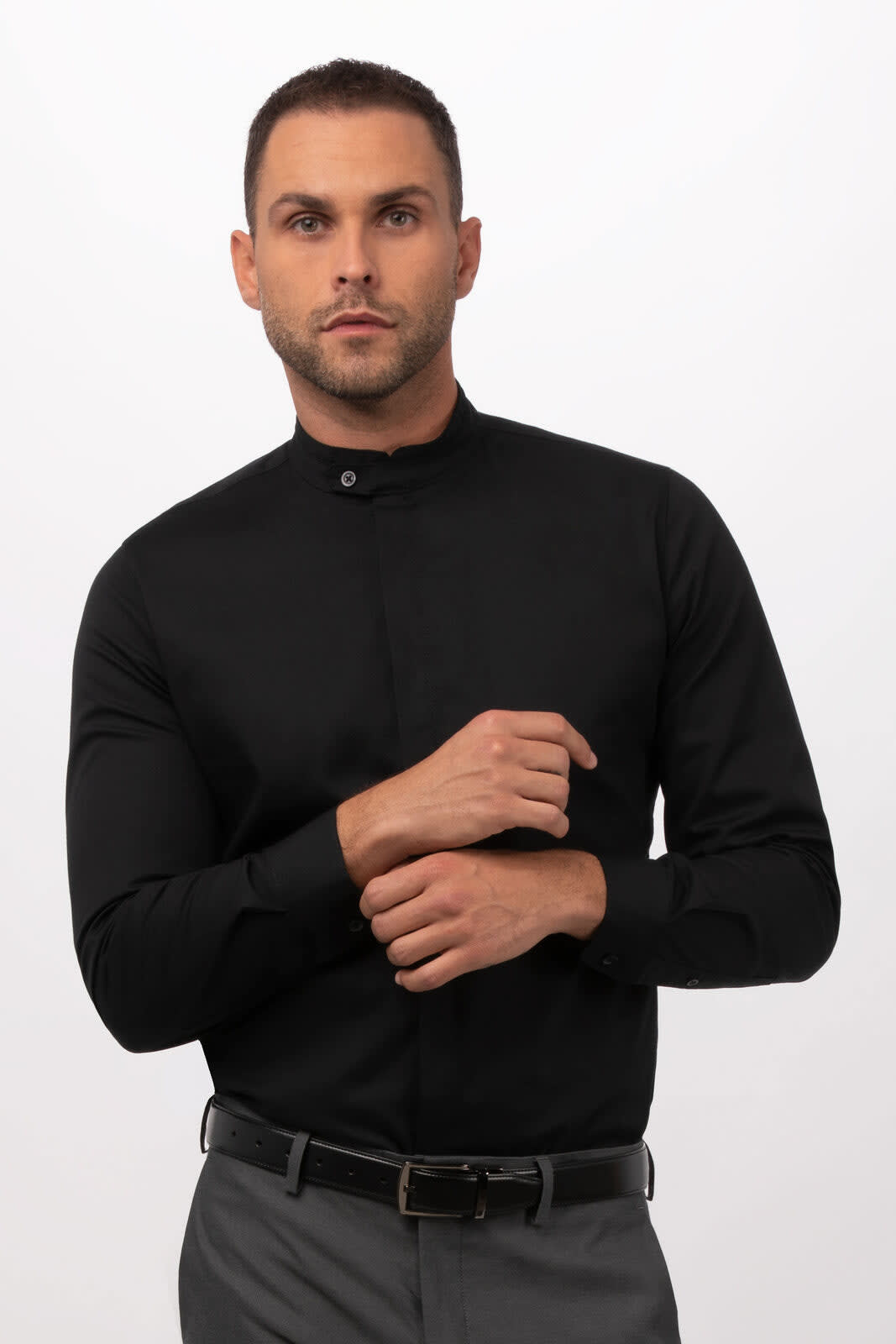 A black button-up shirt with a collar, featuring long sleeves and a fitted style, worn by a model.