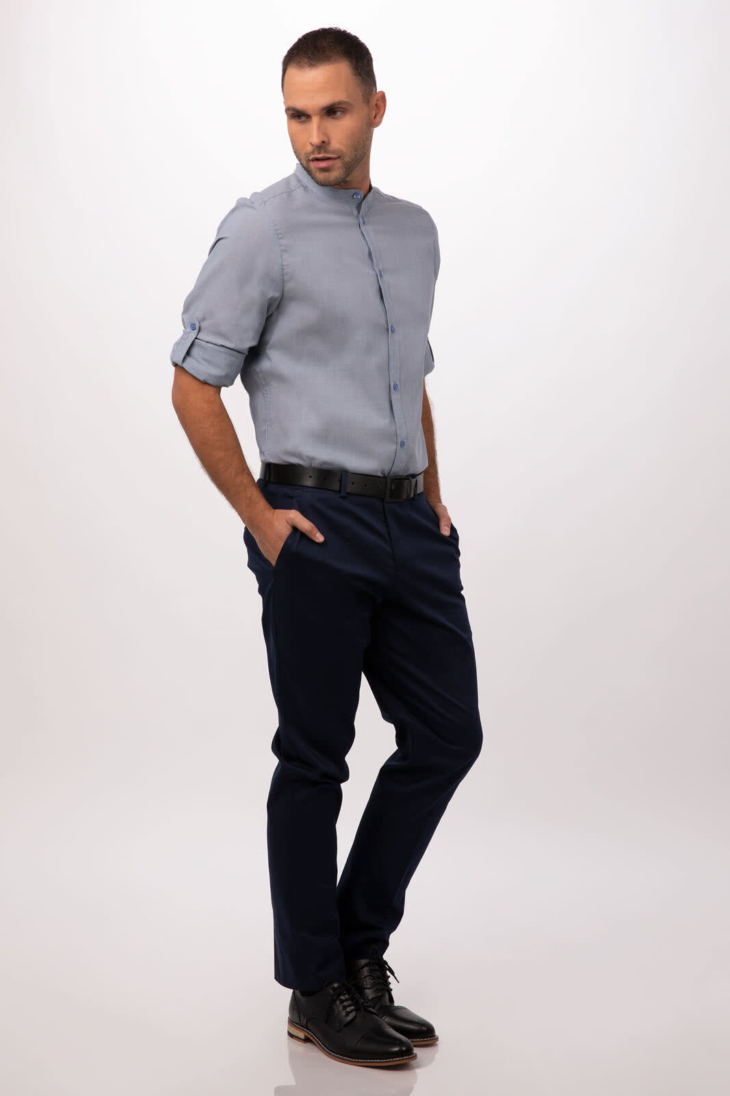 A light blue button-up shirt paired with dark navy trousers, featuring a model in a relaxed pose.