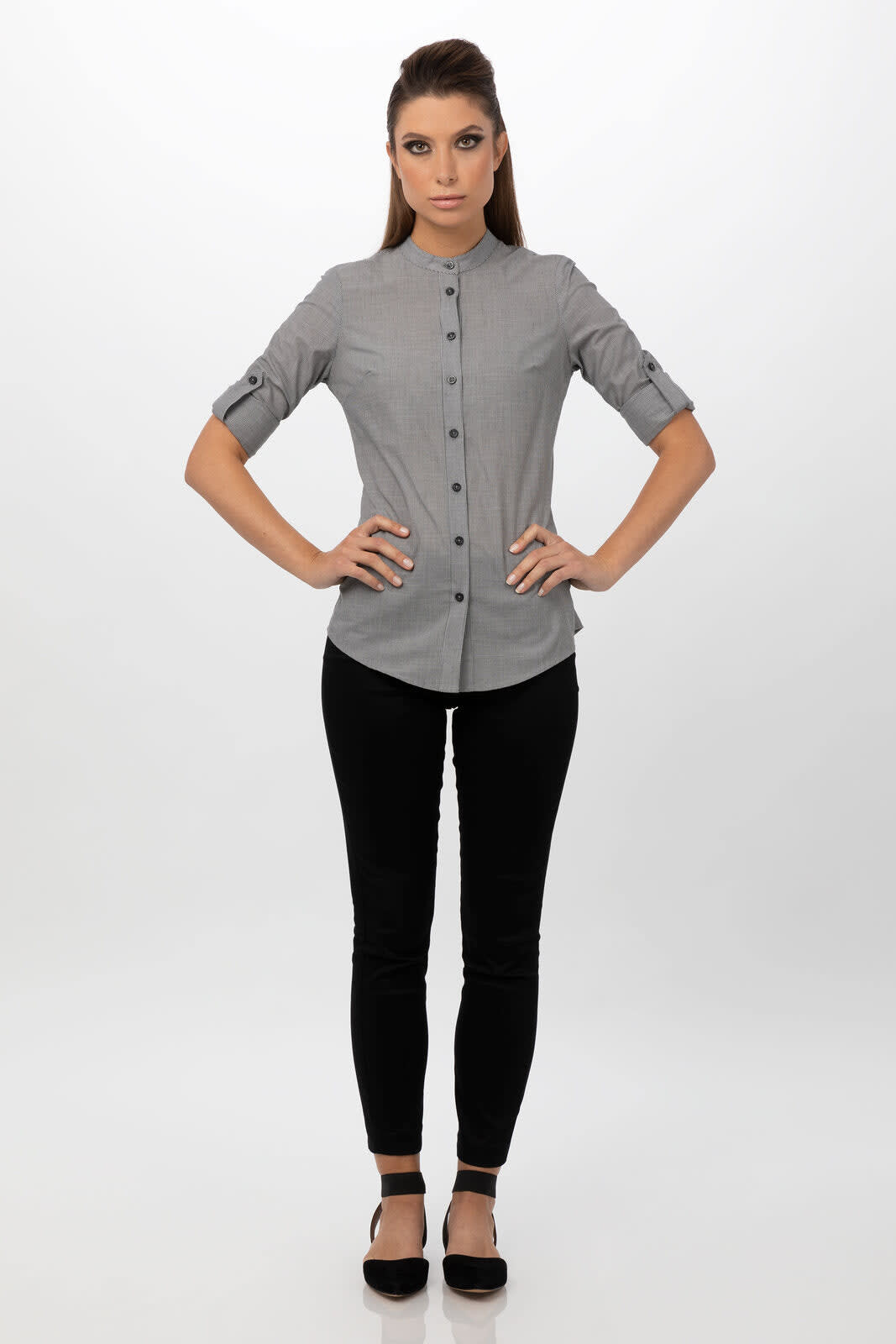 A grey button-up women's shirt with rolled sleeves, paired with black fitted pants and flat shoes.