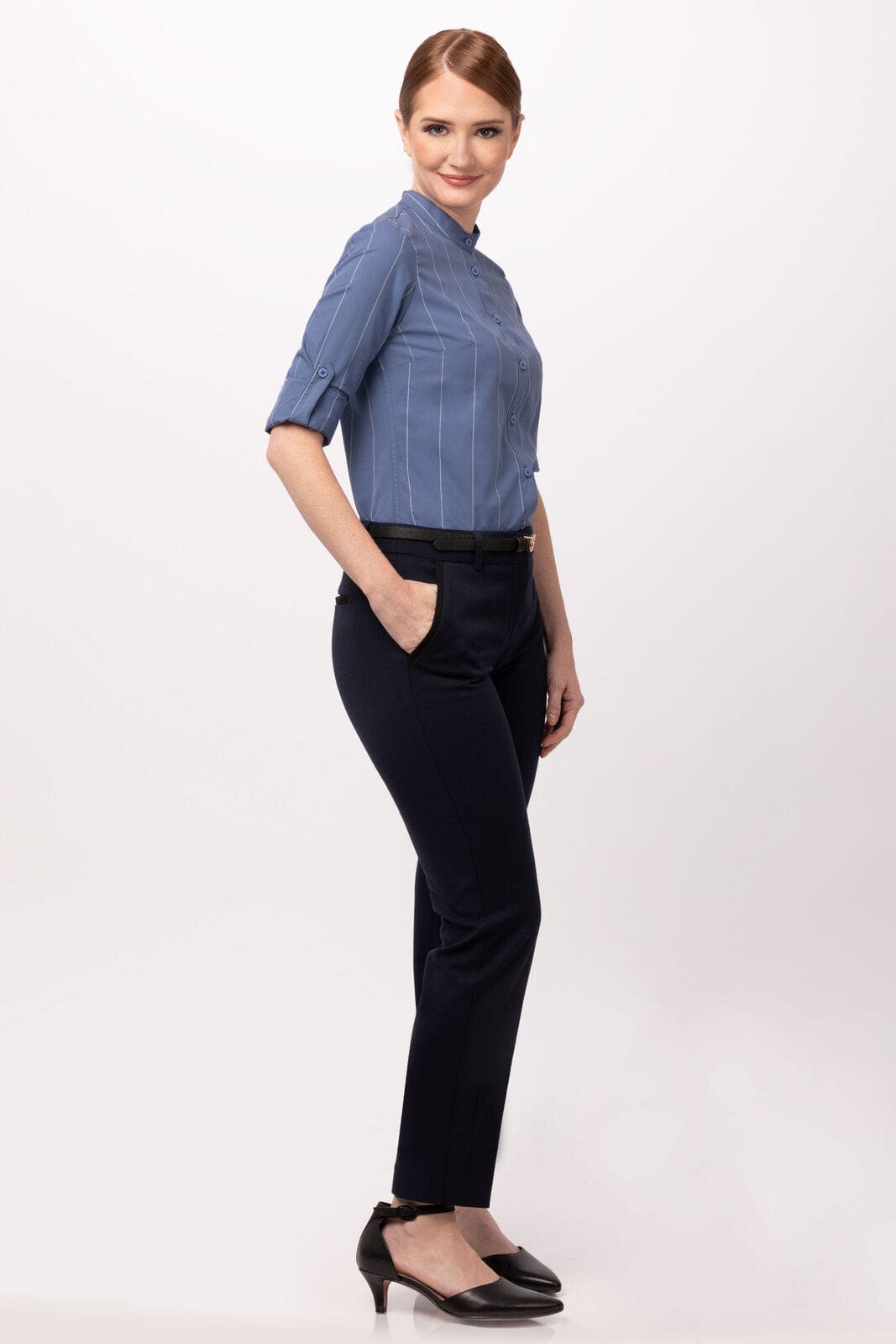 A women's shirt in blue with a striped pattern, featuring long sleeves and a fitted design, paired with black trousers.