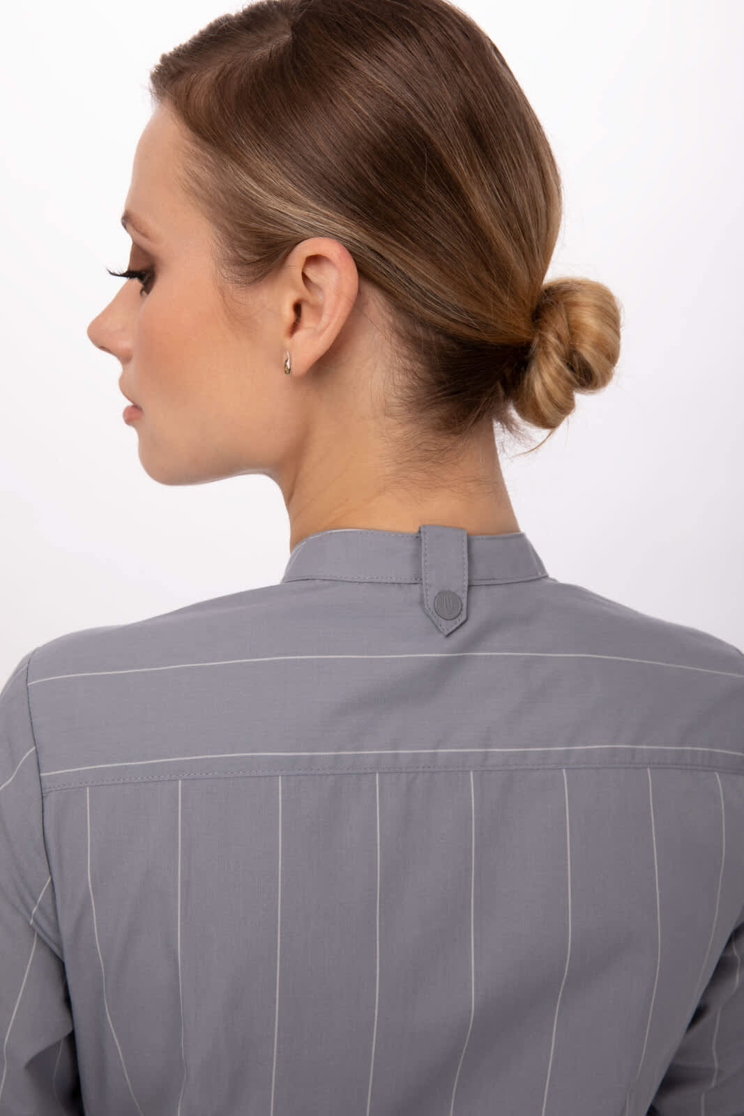 A women's shirt in grey with vertical stripes, featuring a button detail at the back and a branded logo.
