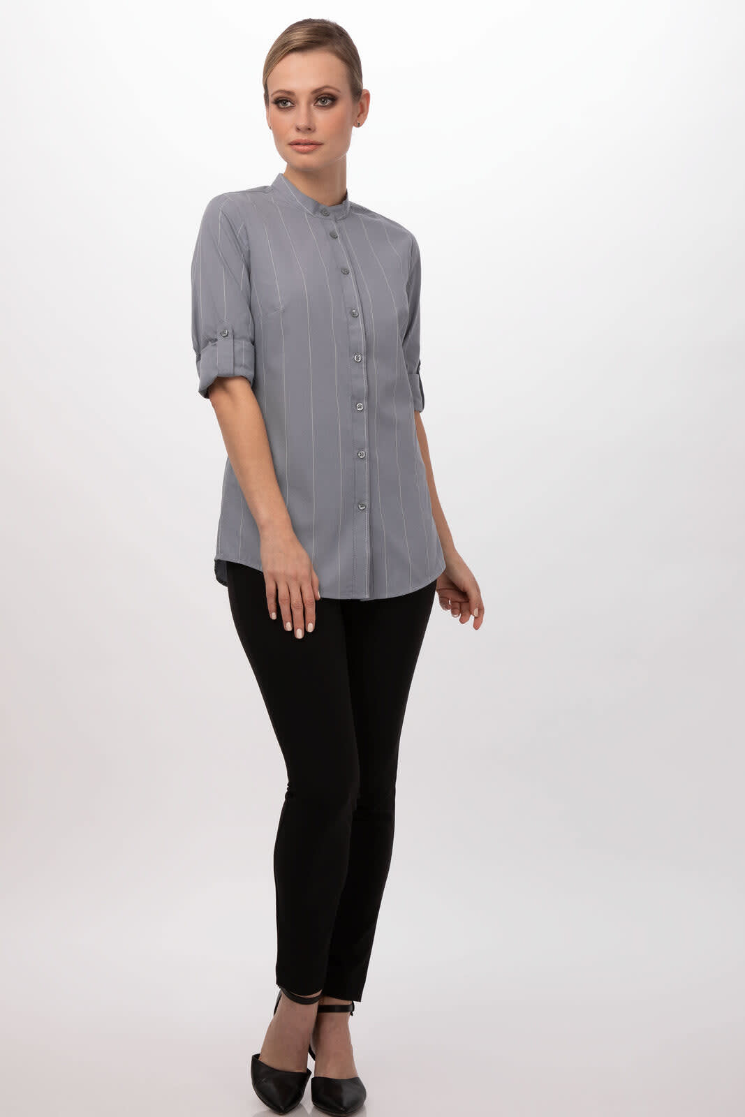 A grey women's shirt with a collared neckline and rolled sleeves, paired with black trousers and shoes.