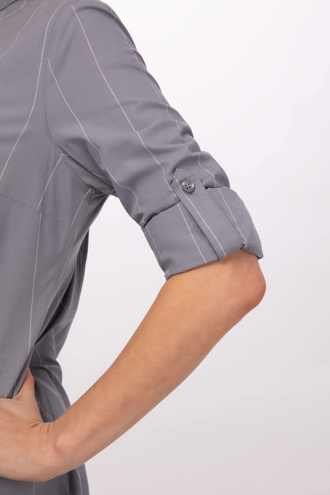 A grey women's shirt with rolled-up sleeves and pinstripe detailing. It features a button on the sleeve.