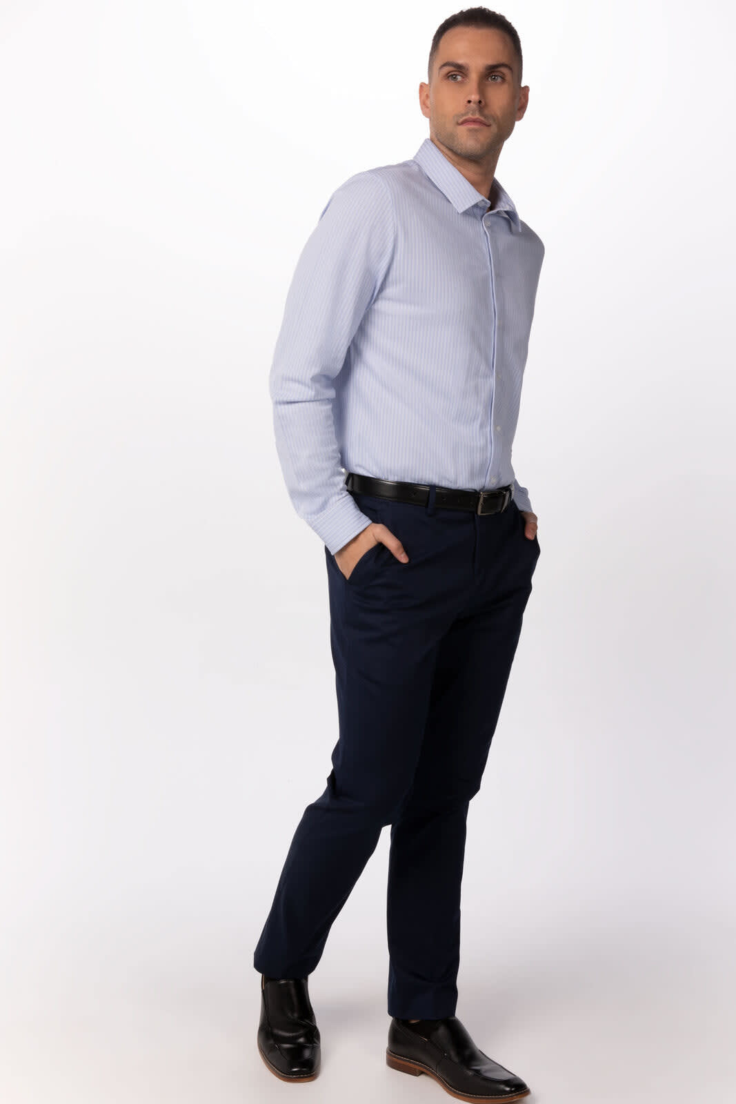 A light blue button-up shirt featuring a logo, paired with navy trousers and black shoes.