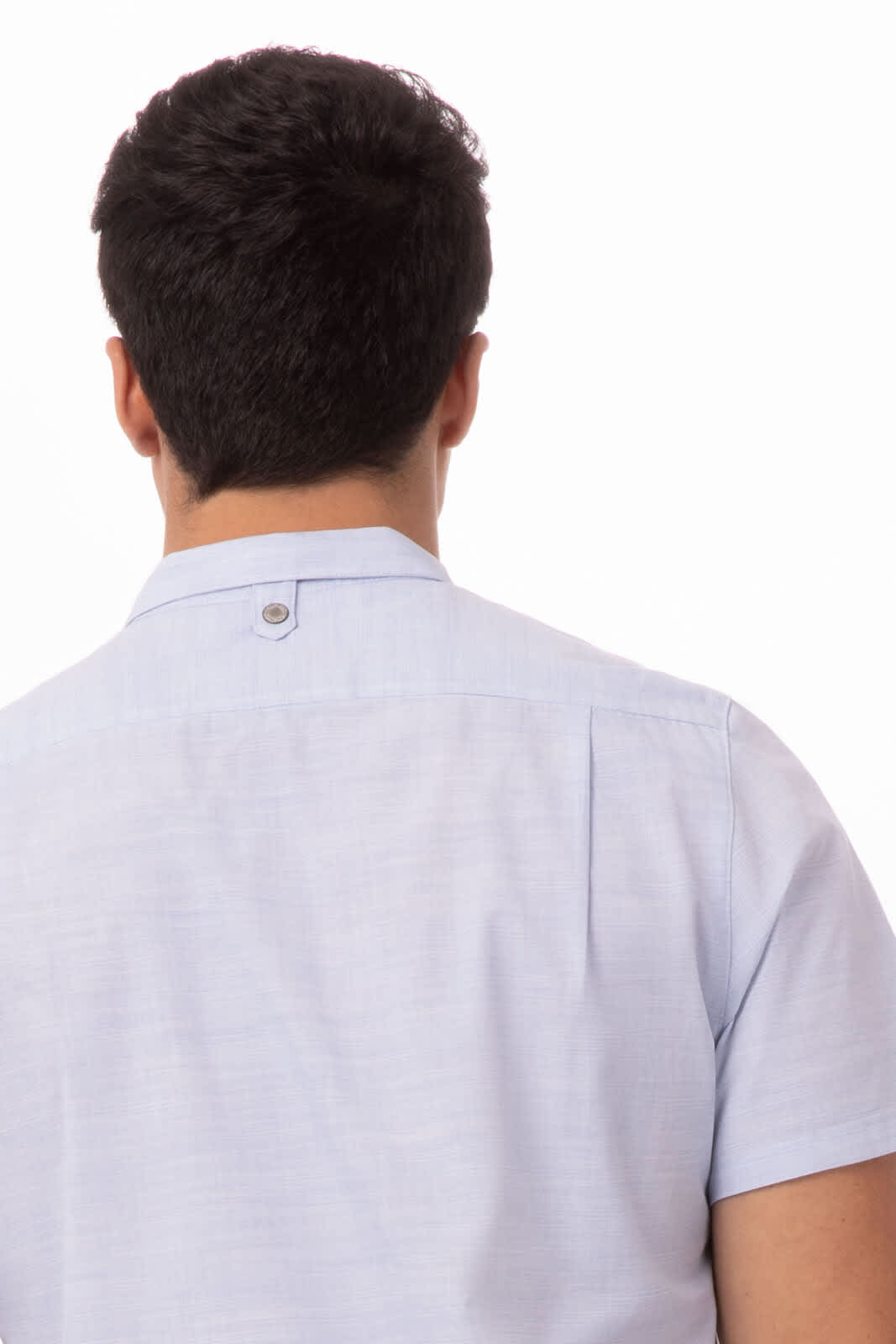 A light blue men's shirt with short sleeves and a back collar button, featuring a small logo.
