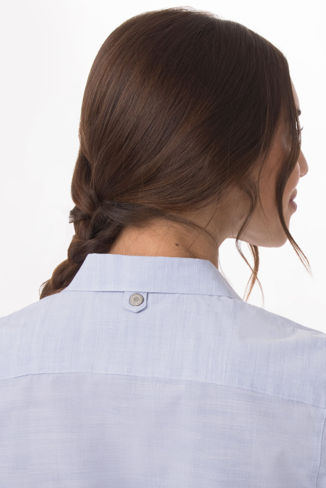 A light blue women's button-up shirt featuring a collar and a shoulder button detail at the back.