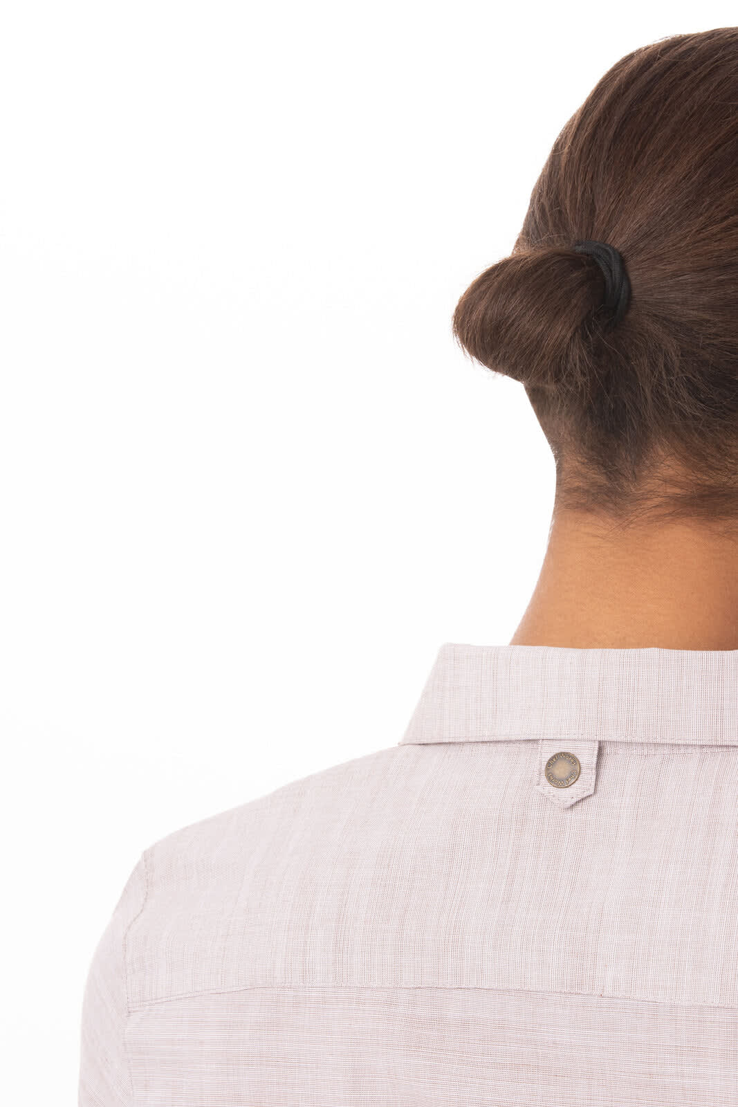 A light pink button-up women's shirt with a collar and a logo detail on the back.