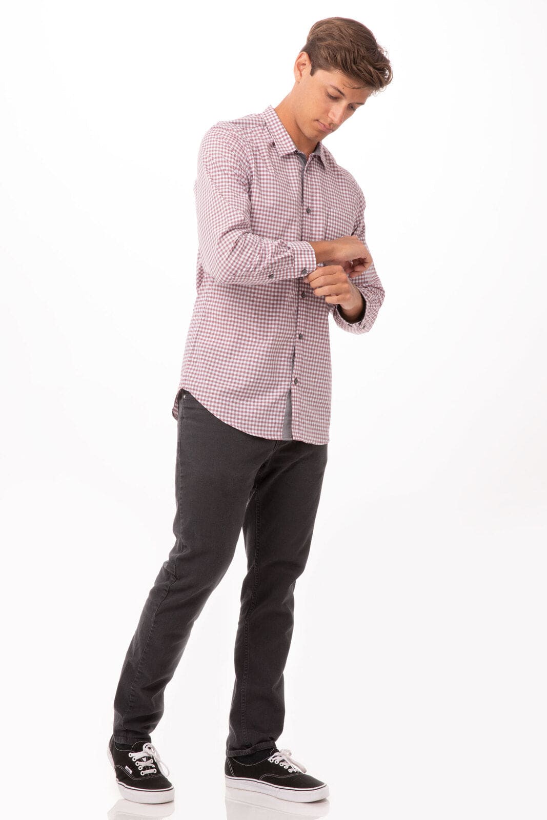A long sleeve men's dress shirt in a modern gingham pattern, featuring shades of red and white, worn with black trousers.