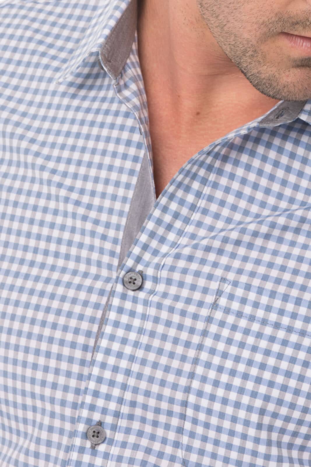 A modern gingham long sleeve dress shirt in blue and white, featuring a collar and button details.