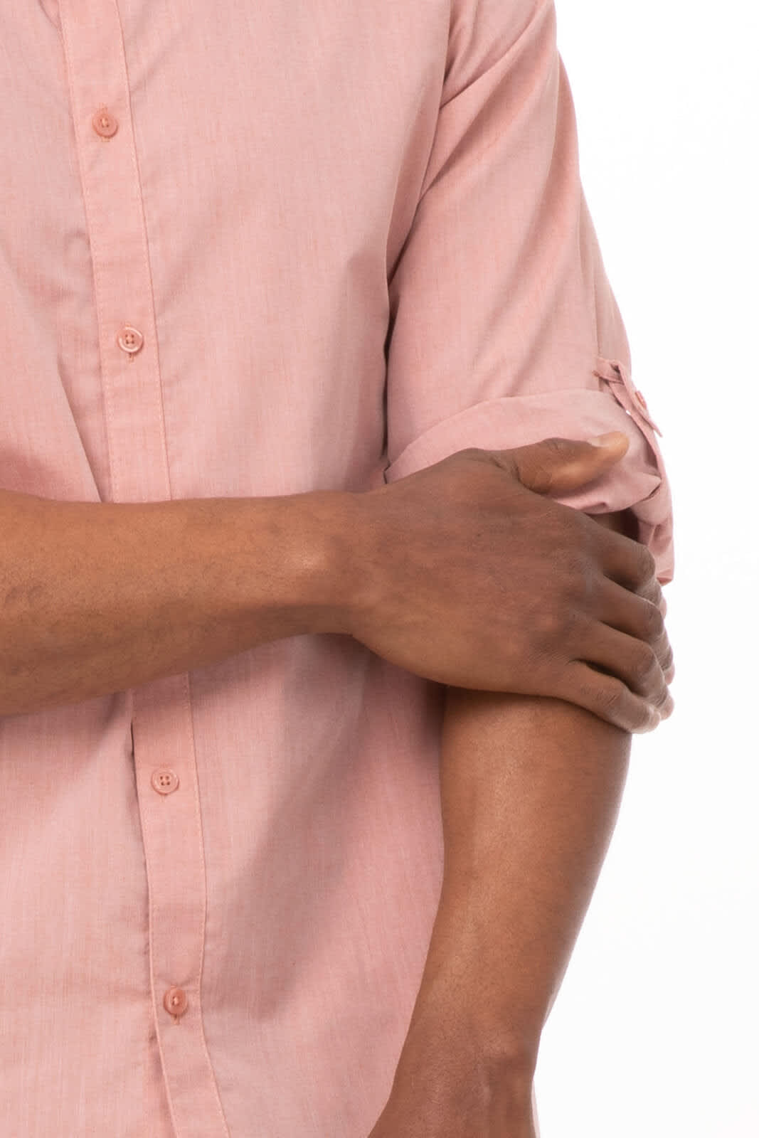 A men's dress shirt in light pink chambray with rolled-up sleeves, featuring buttons and a subtle texture.