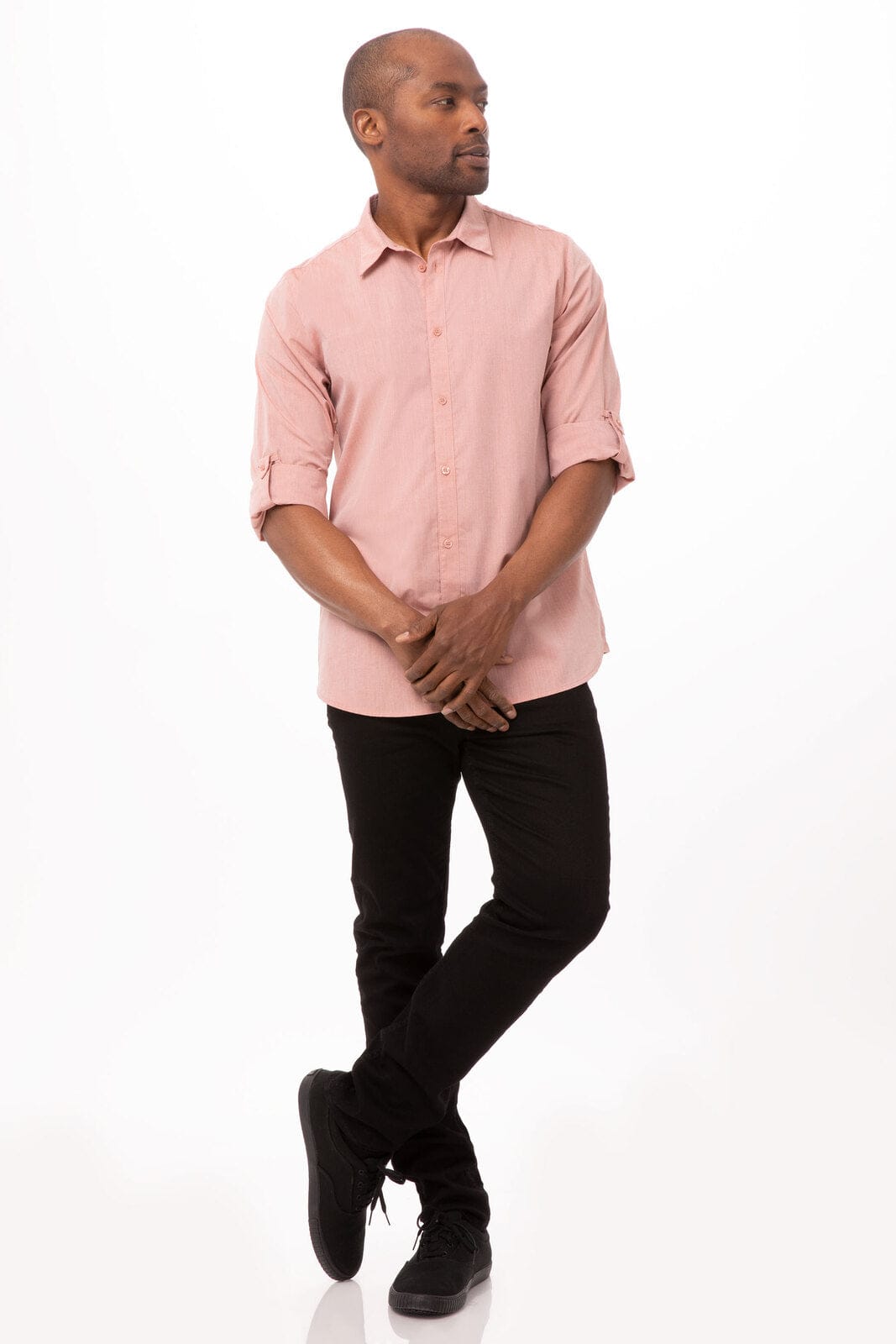 A modern chambray men's dress shirt in light pink, paired with black trousers and shoes, featuring a logo.