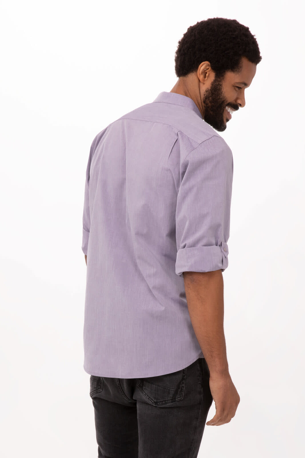 A modern chambray men's dress shirt in light blue, featuring rolled sleeves and a back view of a model.