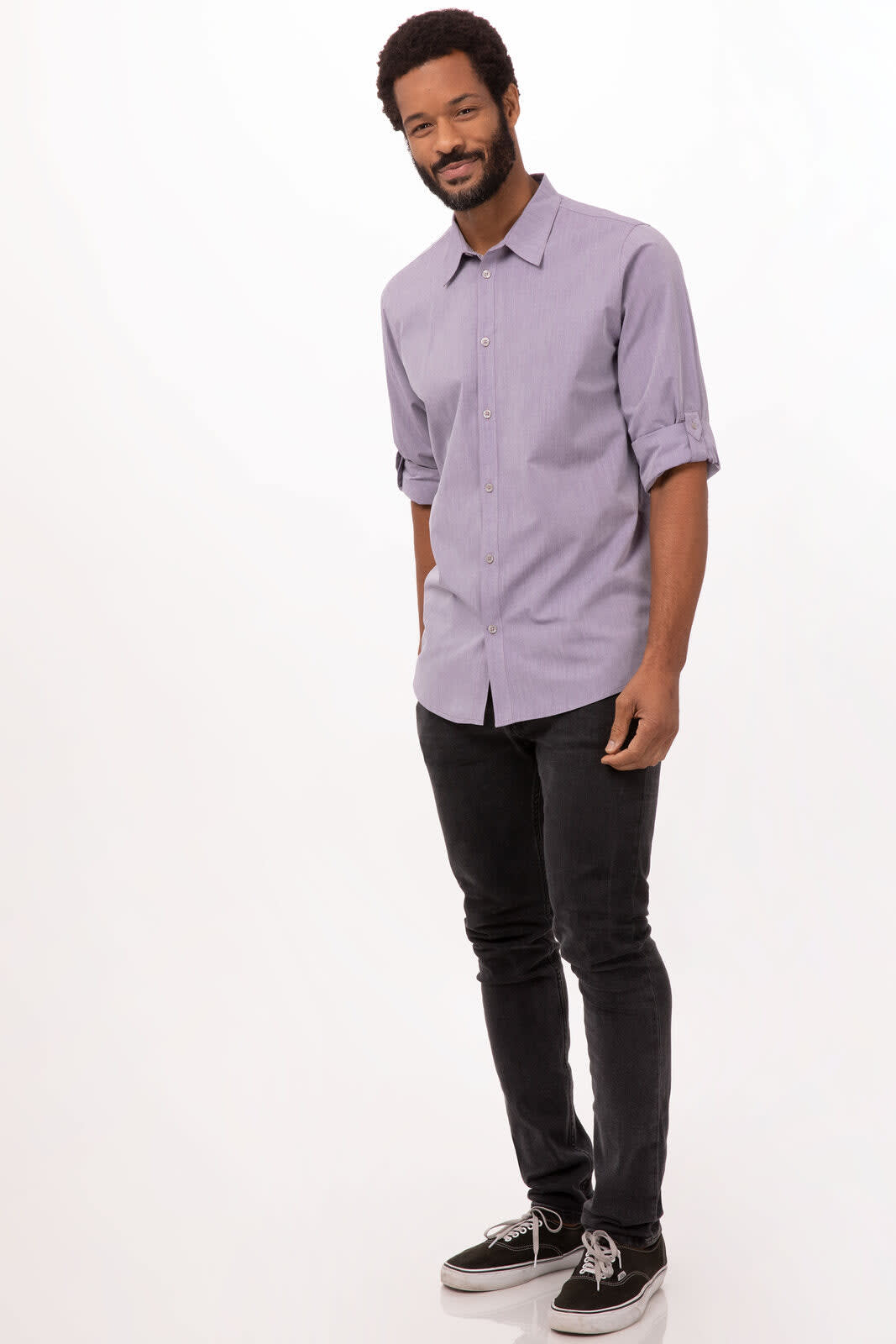 A men's button-up dress shirt in modern chambray, featuring a light purple hue, worn with black jeans and casual shoes.