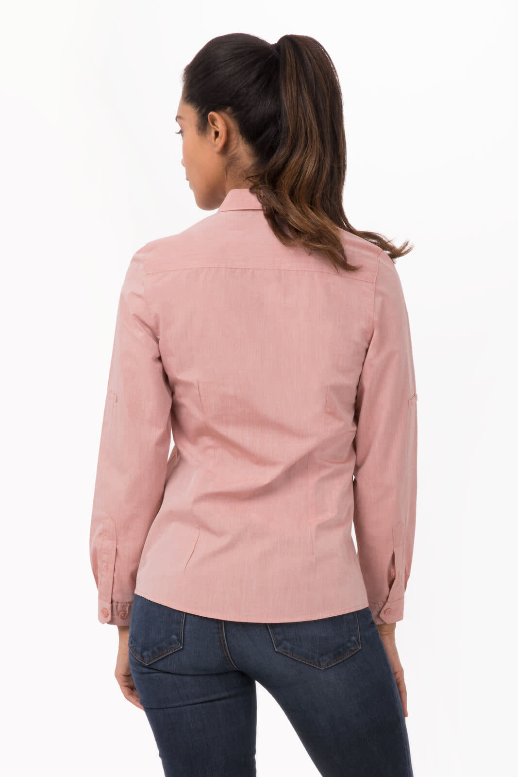 A women's chambray dress shirt in light pink, featuring long sleeves and a fitted design, with a logo on the back.